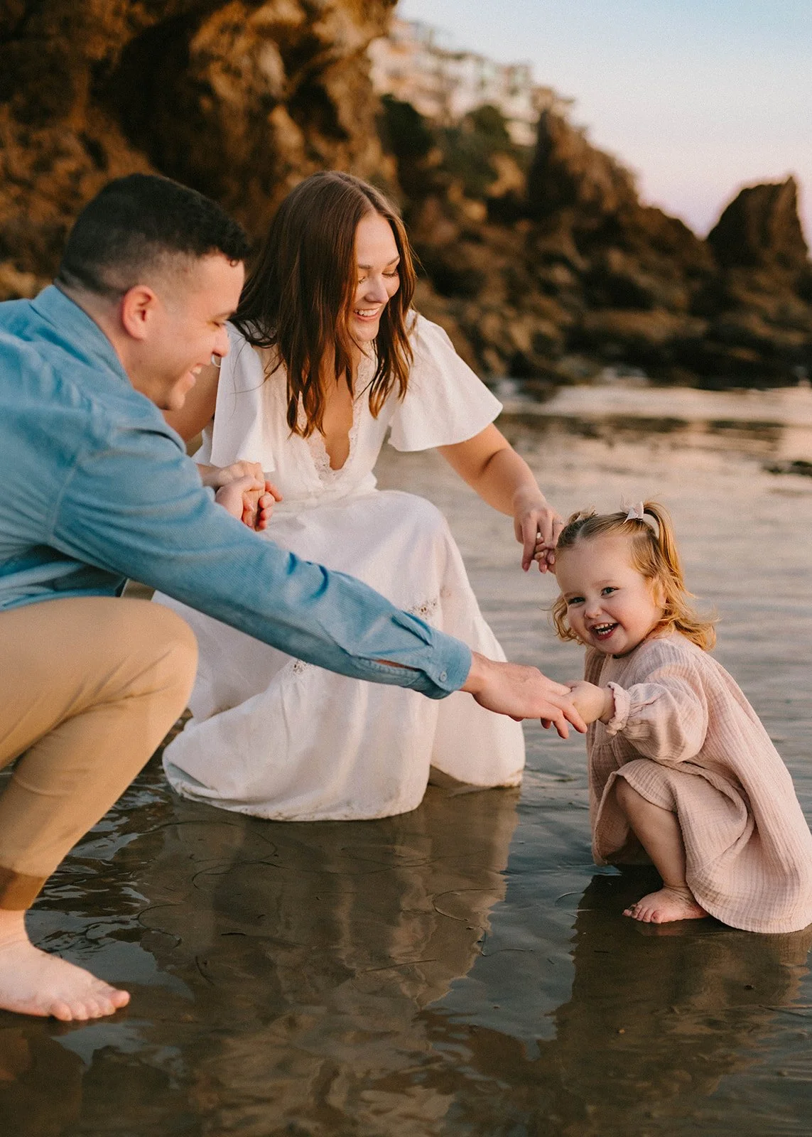 Carefree family laughing and playing at Laguna Beach — Best candid family photographers in Laguna Beach — Captured by Tesla Rae Photo