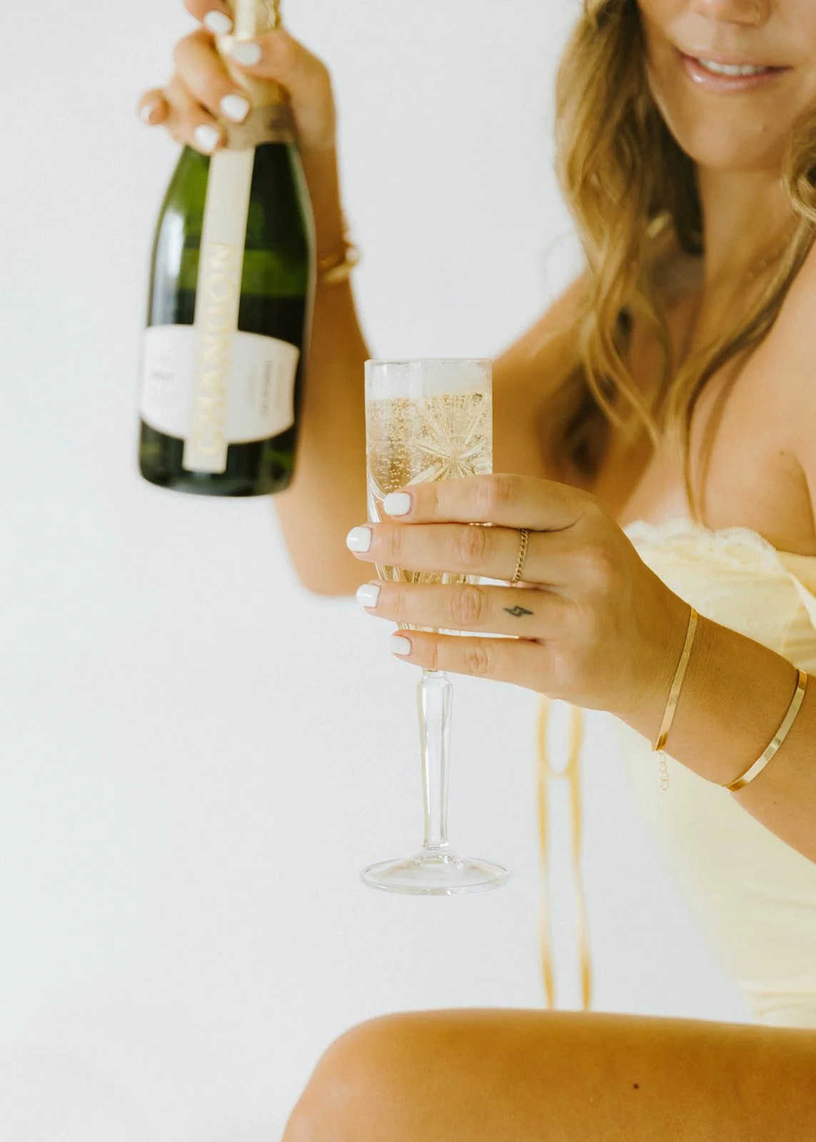 Celebratory, lifestyle birthday portraits of girl holding champagne glass next to champagne bottle in Huntington Beach, natural light studio — Best brand photographers in Huntington Beach — Captured by Tesla Rae Photo