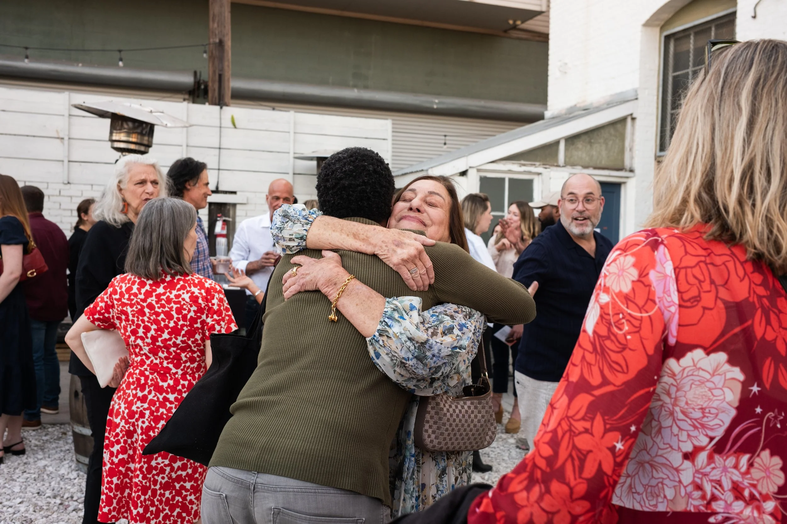 Copy of Laurie hugging guest.jpg