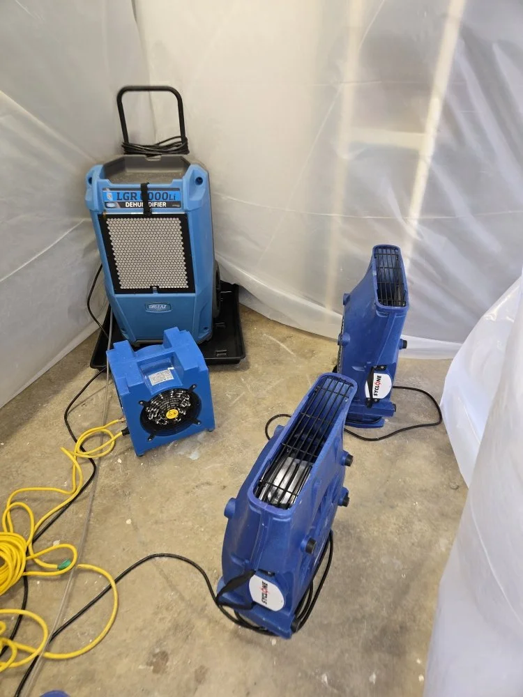 Blue industrial air movers and a dehumidifier in action during water damage restoration service in Vancouver, WA.