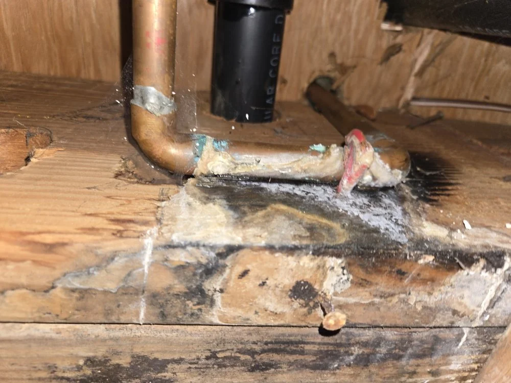 Corroded copper pipe with a makeshift repair and water damage—possible leak may require Mold Remediation Vancouver WA services.