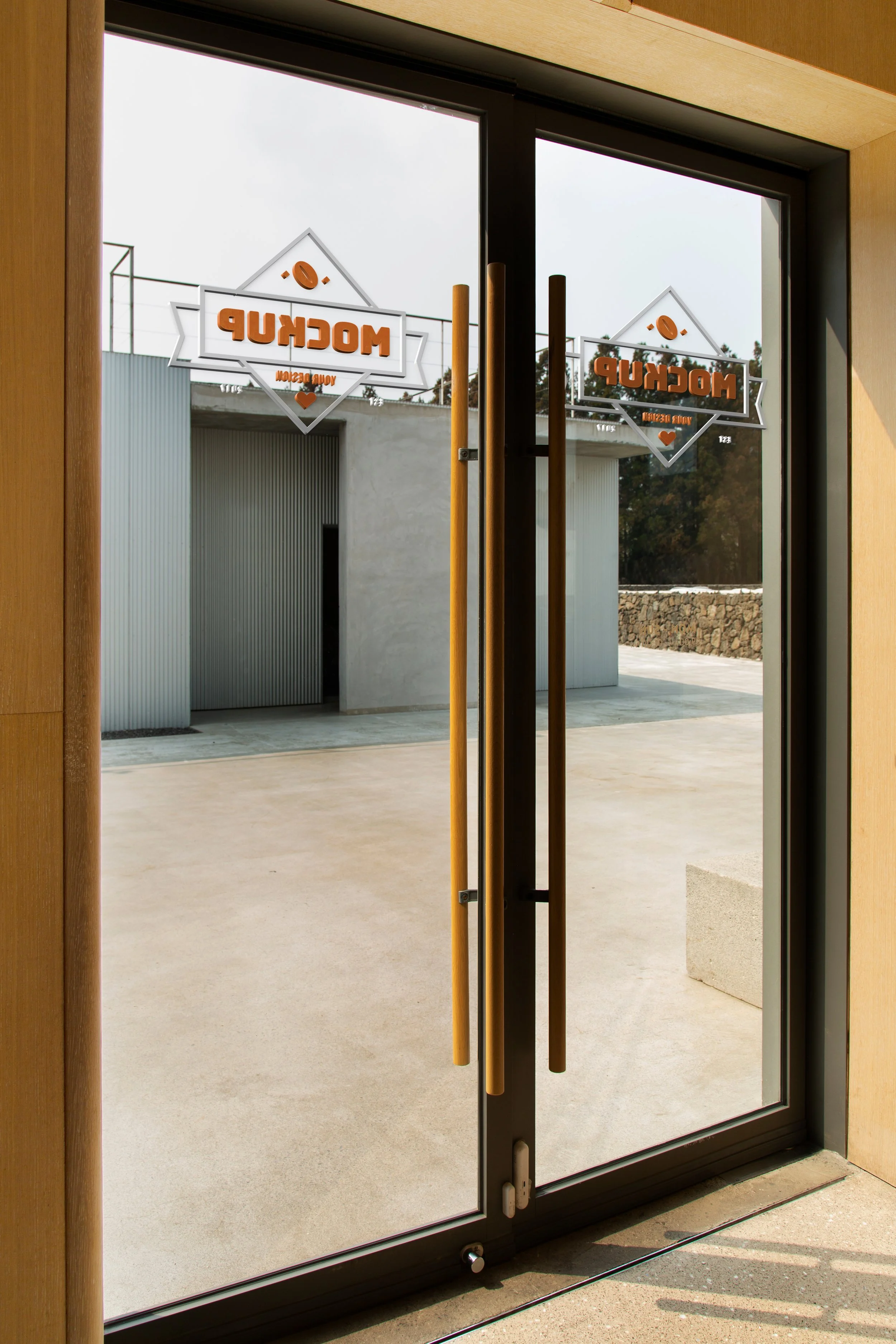 Person wearing red gloves using a glass cutter to cut a piece of glass in a workshop.