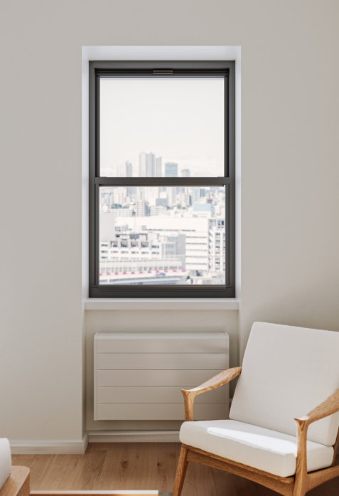A window overlooking a city skyline with modern buildings, in a room with minimalist decor and a white armchair with wooden armrests.