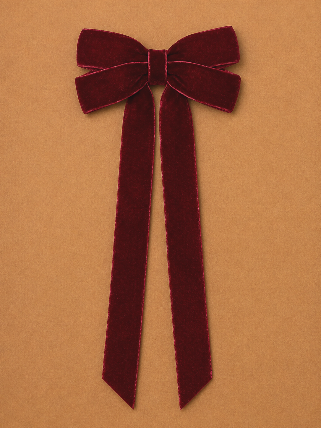 A burgundy velvet hair bow with long trailing tails, a simple DIY accessory for finishing an Elf Jr. the Musical costume. This handmade touch adds an old-world holiday accent to hairstyles for ensemble or background elf performers in school theater