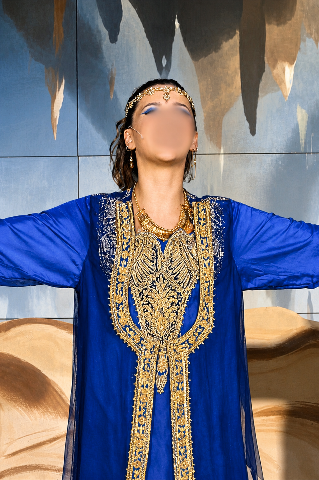 Genie costume for Aladdin Jr with royal blue robe, intricate gold embroidery, and gold headpiece during a school musical performance.
