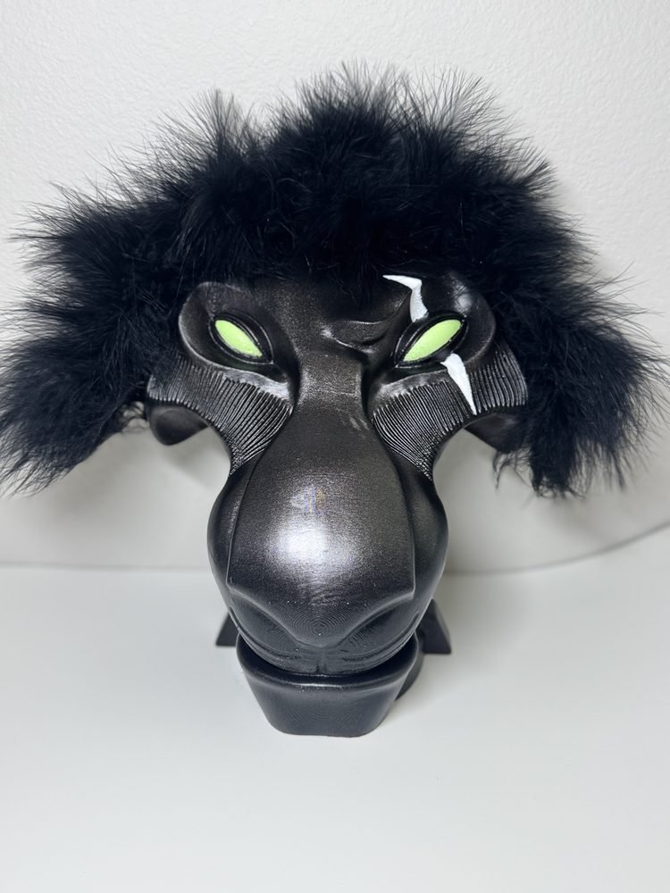 Black lion costume mask with dark faux fur mane, green eyes, and sculpted facial features, designed for Scar in Disney's The Lion King JR.