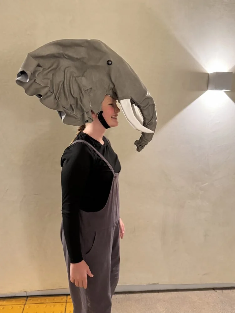 Lion King JR – Elephant Headpiece Costume: Side view of an oversized handmade elephant headpiece worn by a performer for a school theater production.