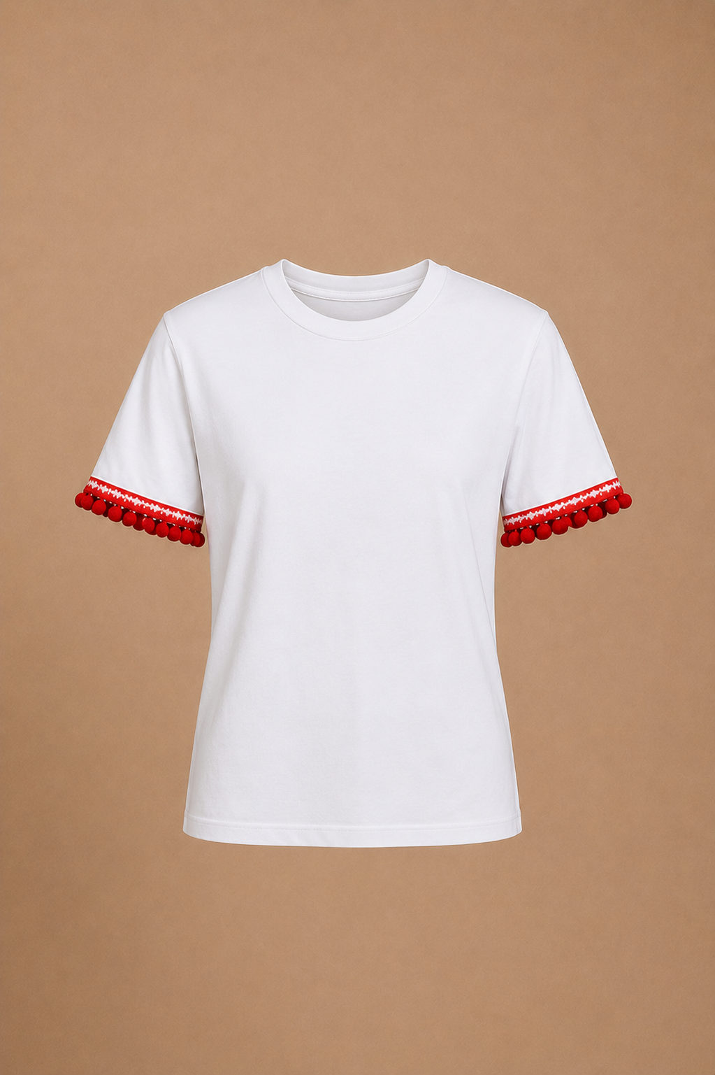 Budget-friendly white t-shirt upgraded with red pom-pom and star-patterned festive trim on sleeves for Elf Jr. the Musical — a $2.99 base piece transformed into a stage-ready elf costume top for school theater production