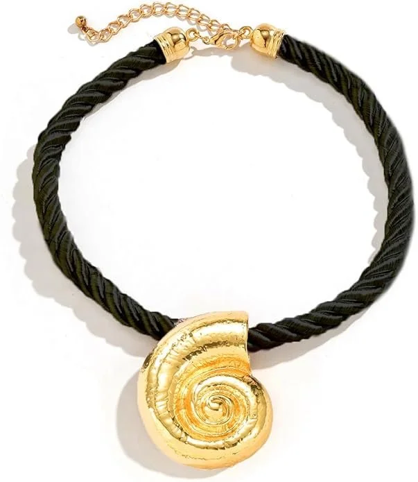 Gold shell necklace worn as Ursula’s magic pendant, representing the shell that captures Ariel’s voice, paired with a black cord for clear visibility onstage in a youth theater production.