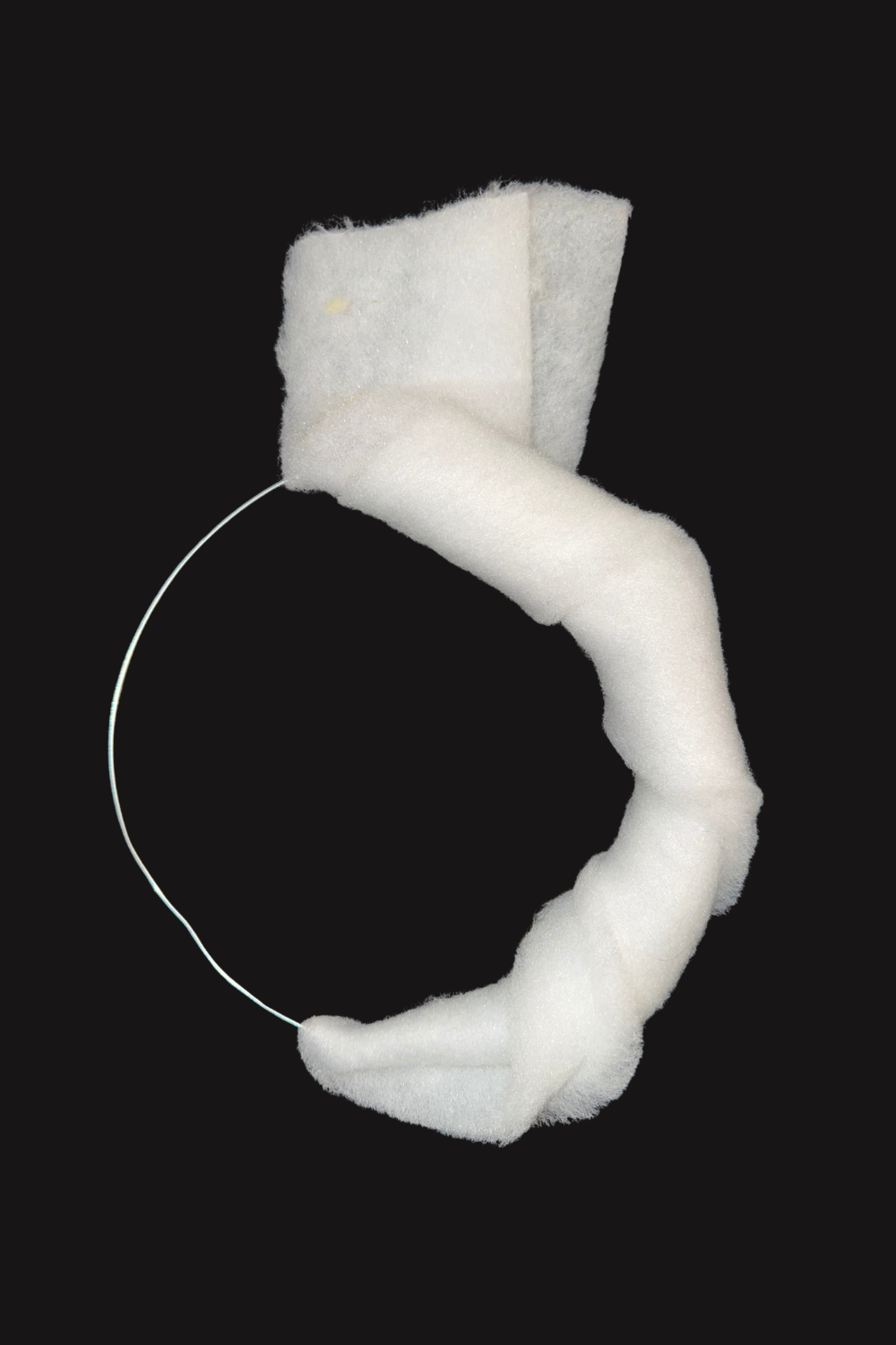Soft batting was wrapped around part of the wire ring to build volume and soften the structure.