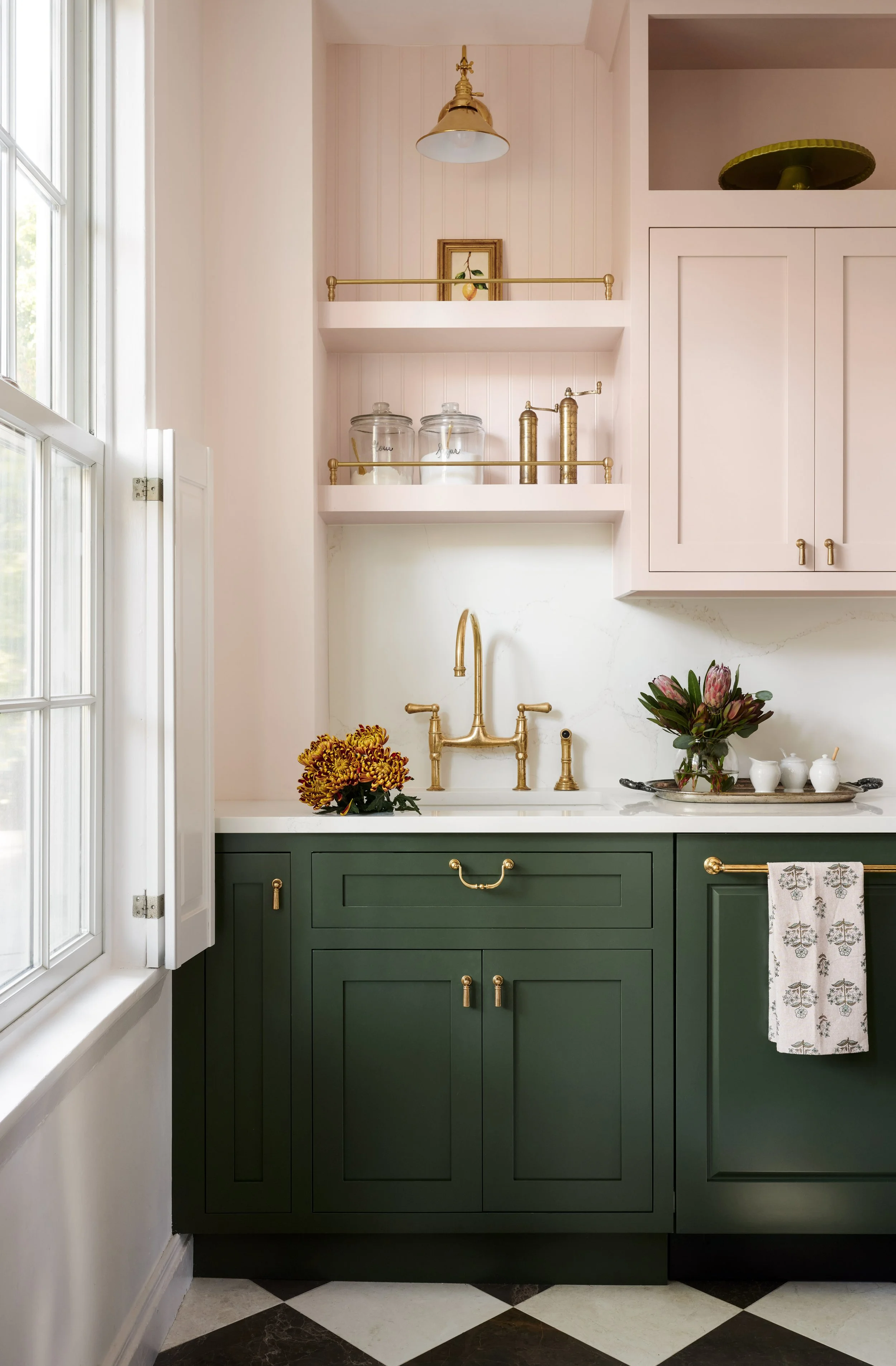 Blush and green kitchen with brass bridge faucet and gallery-rail shelves at Summer Street, Newburyport, designed by Ivory & Bone Interiors