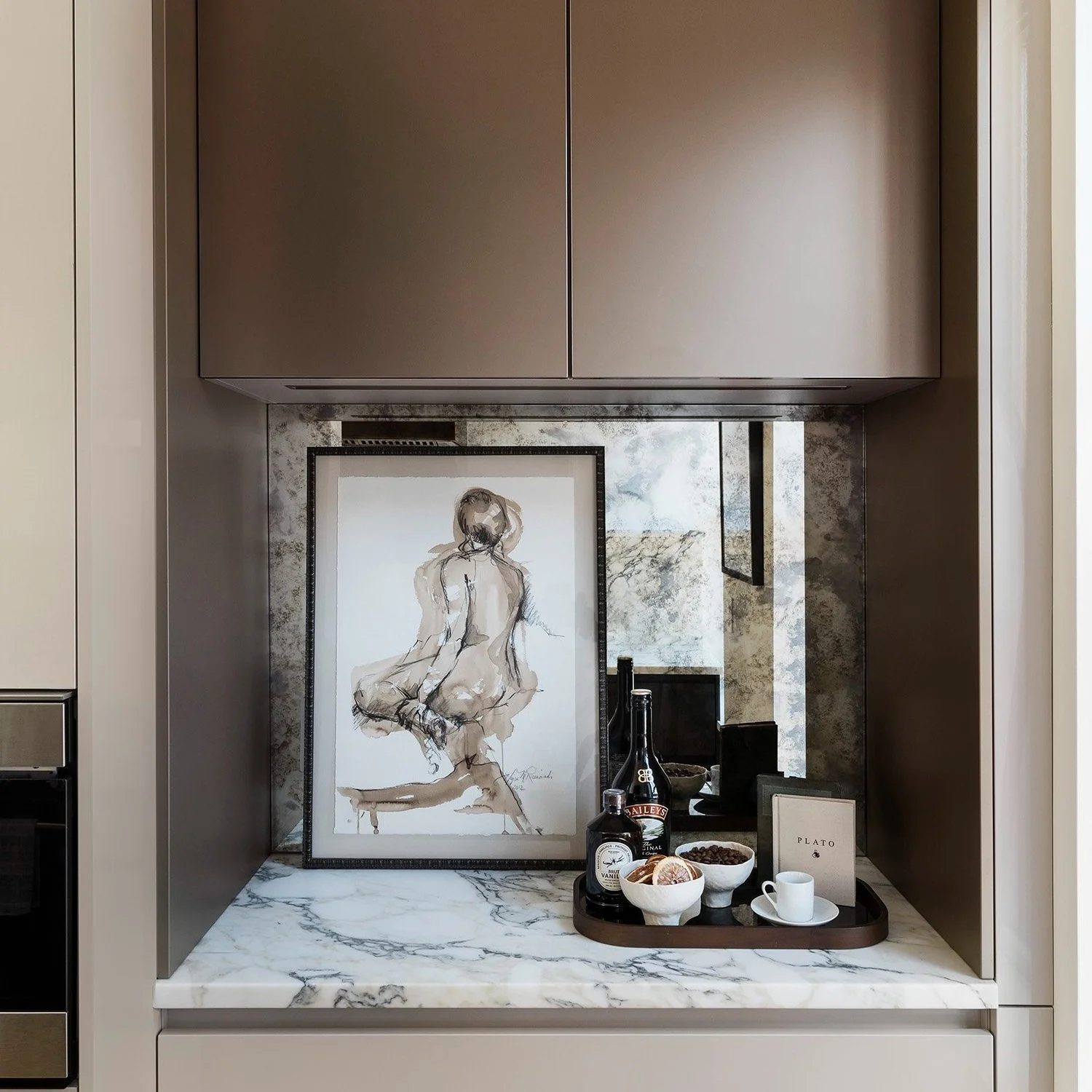 Custom millwork built-in bar with marble counter and antique mirror backsplash in a South End Boston home