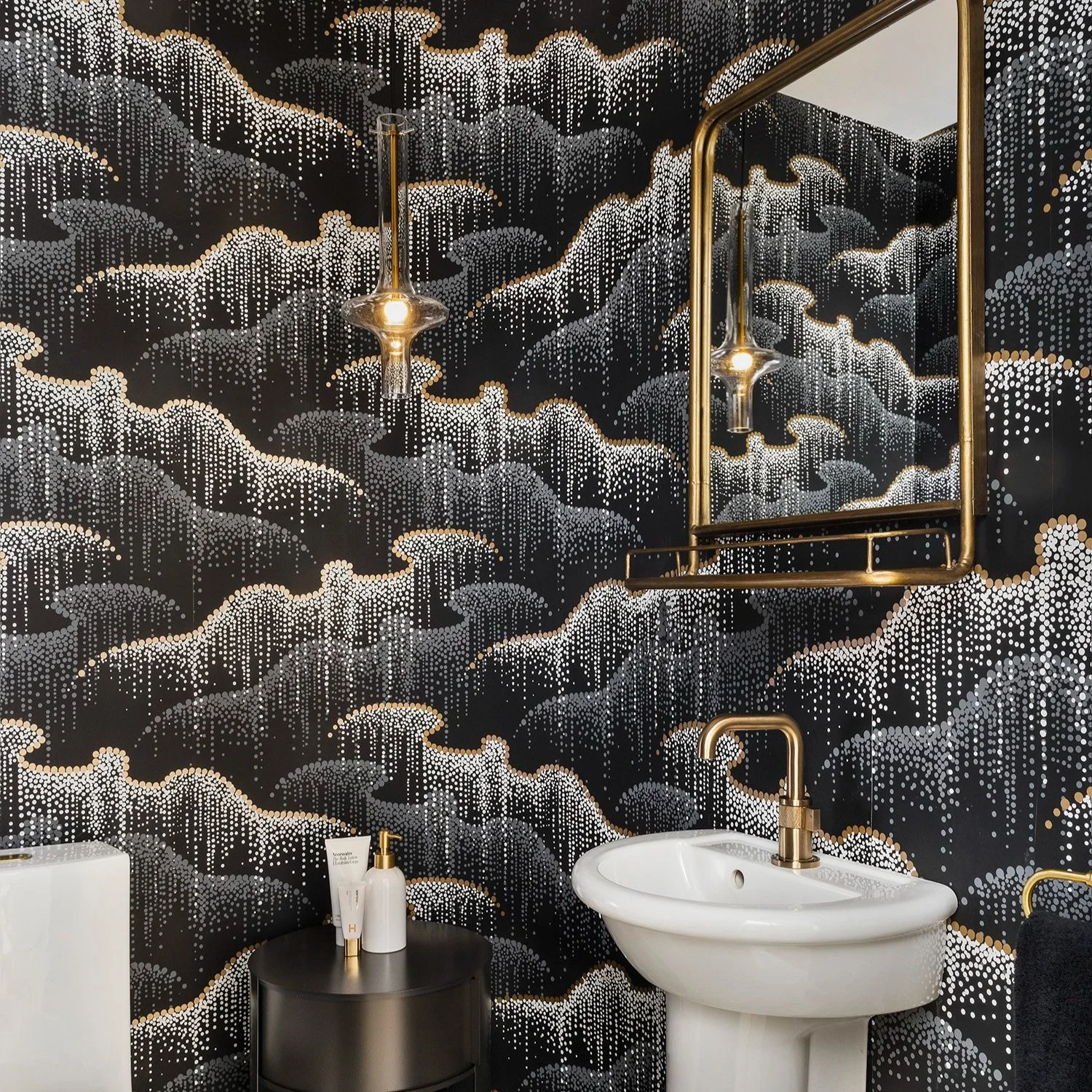 Cloud-wallpapered powder room with brass mirror and pendant in a South End Boston residence on Clarendon Street