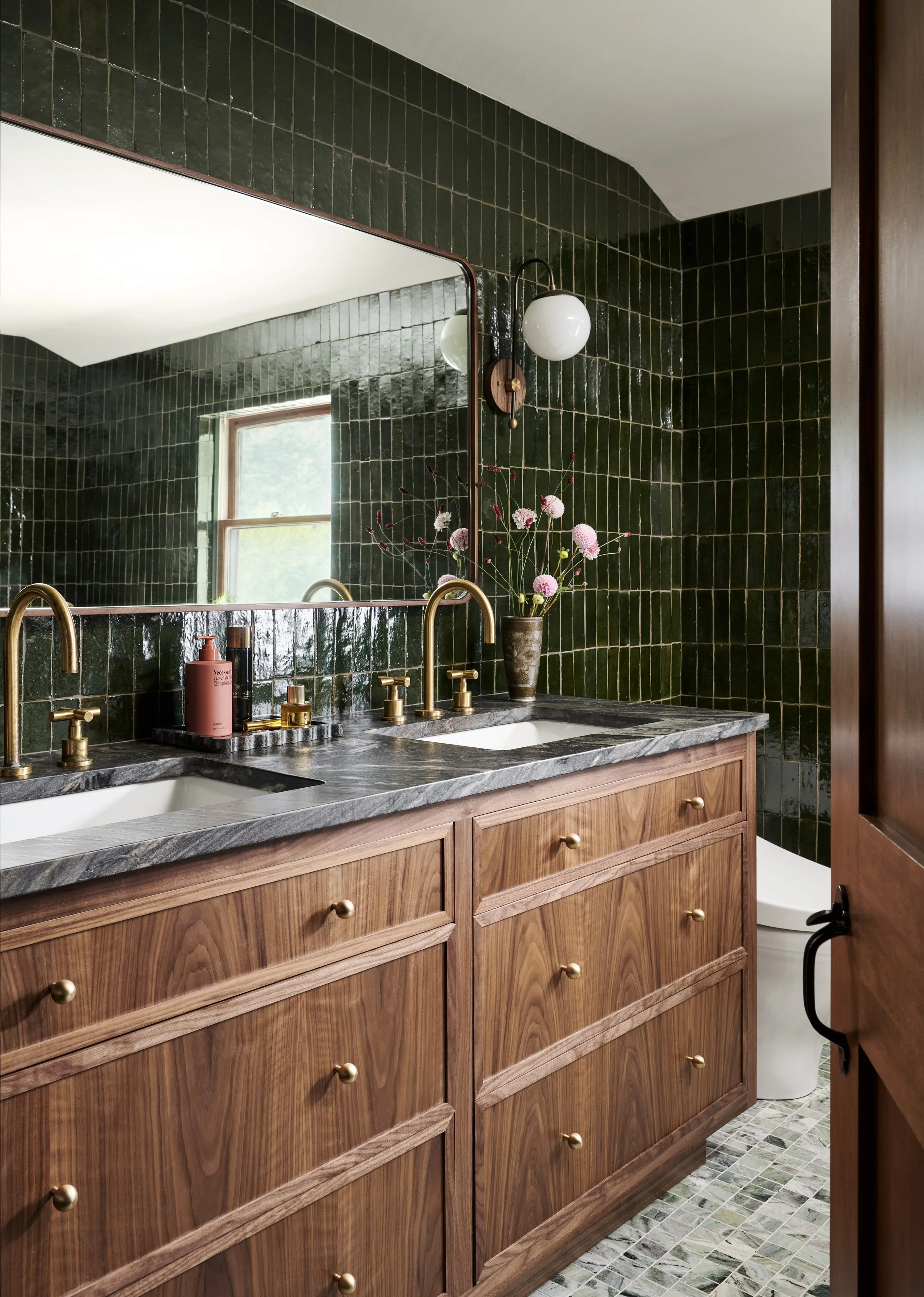 Primary bathroom with walnut double vanity, brass faucets and deep green glazed tile by Ivory & Bone Interiors, Groveland, MA