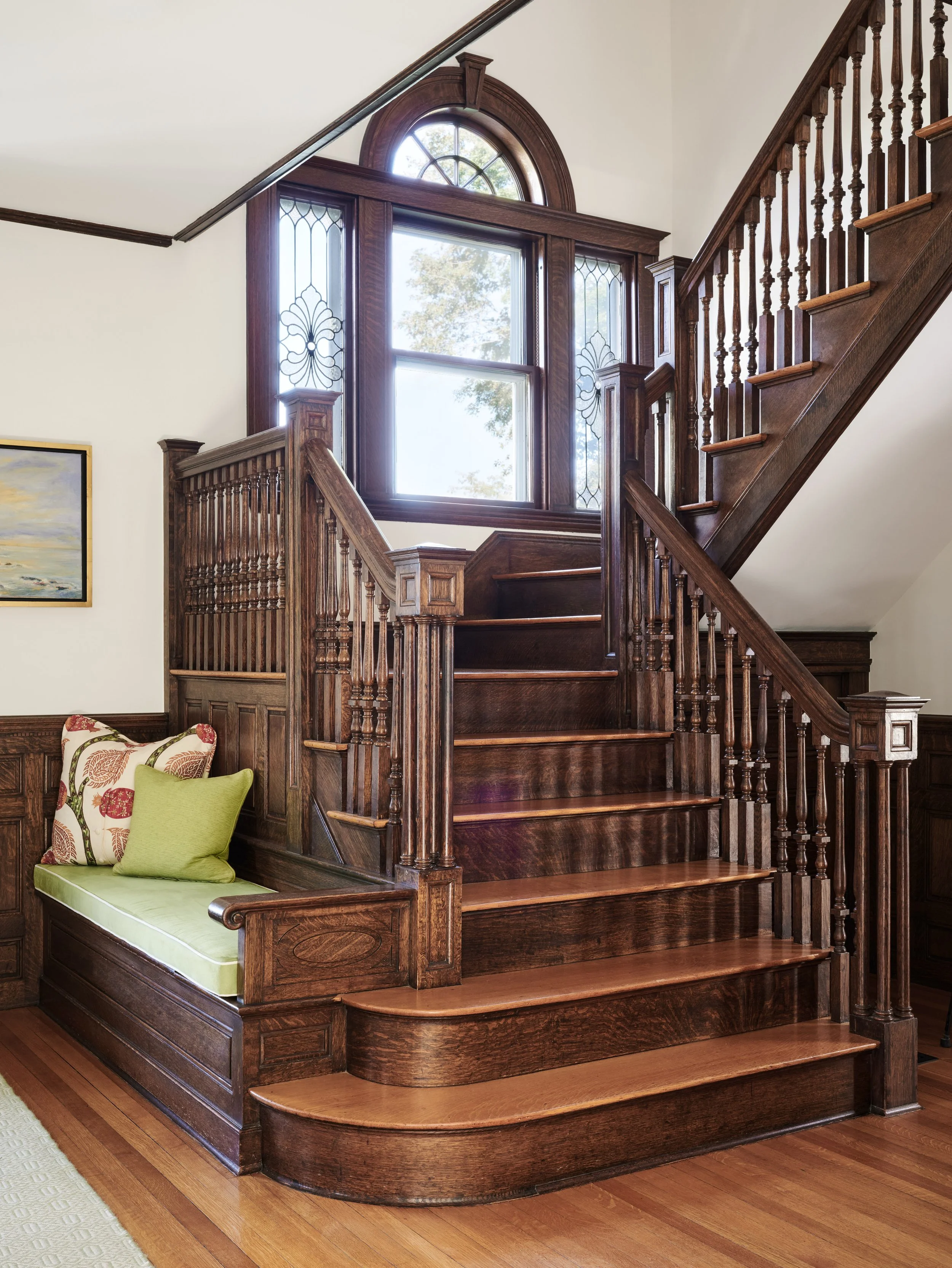 Carved wood staircase with landing window seat at Whitmore Road, Newburyport, designed by Ivory & Bone Interiors