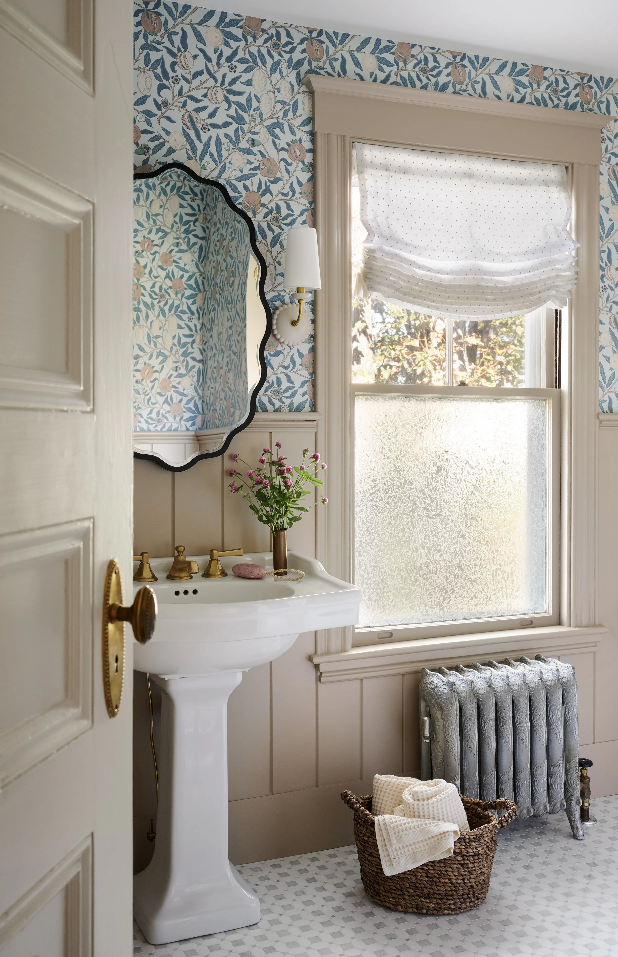 Guest bathroom with blue leaf wallpaper, scalloped mirror and pedestal sink at Whitmore Road, Newburyport, designed by Ivory & Bone Interiors