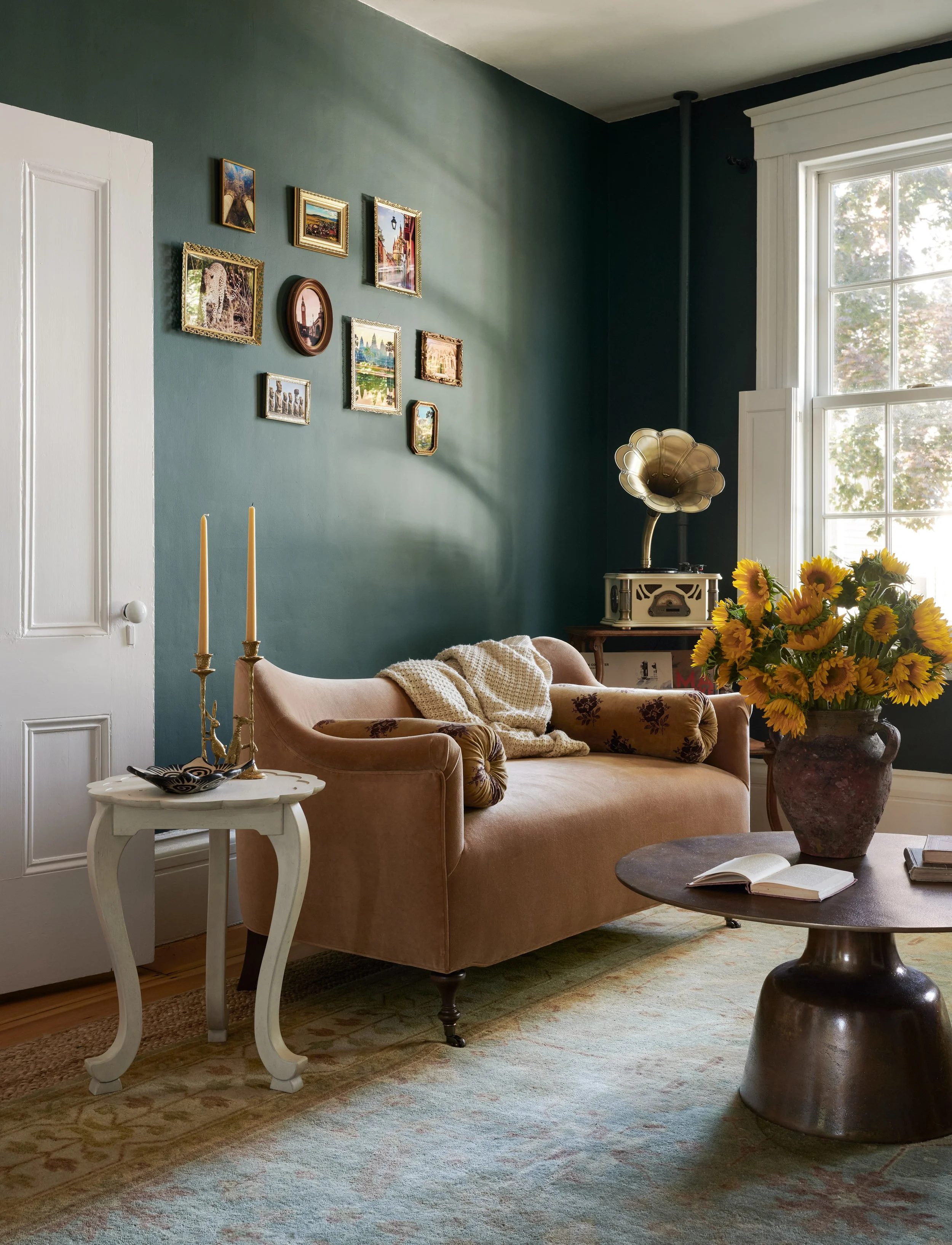 Blush velvet settee under a gilt-framed gallery wall at Summer Street, Newburyport, designed by Ivory & Bone Interiors