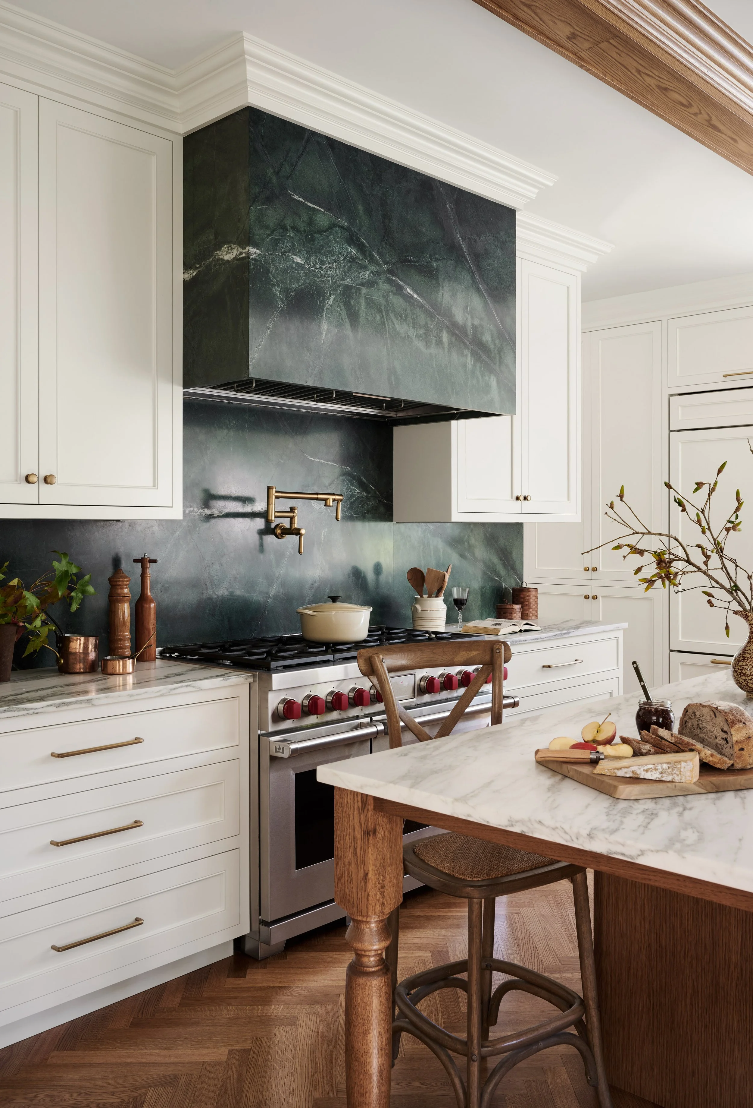 Green marble range hood over a professional range at Whitmore Road, Newburyport, designed by Ivory & Bone Interiors
