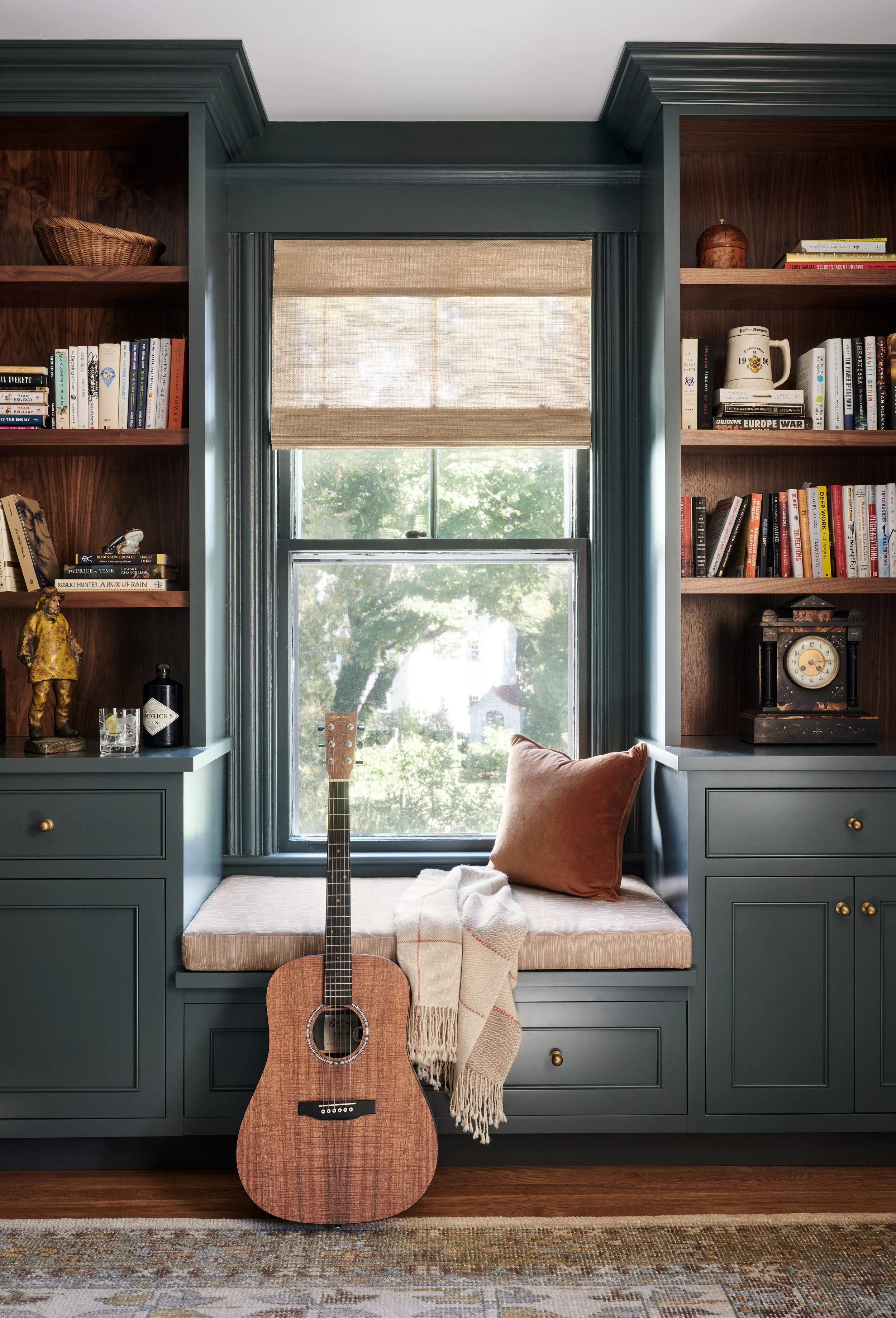 Deep green reading nook with built-in bookshelves and window seat at Whitmore Road, Newburyport, designed by Ivory & Bone Interiors