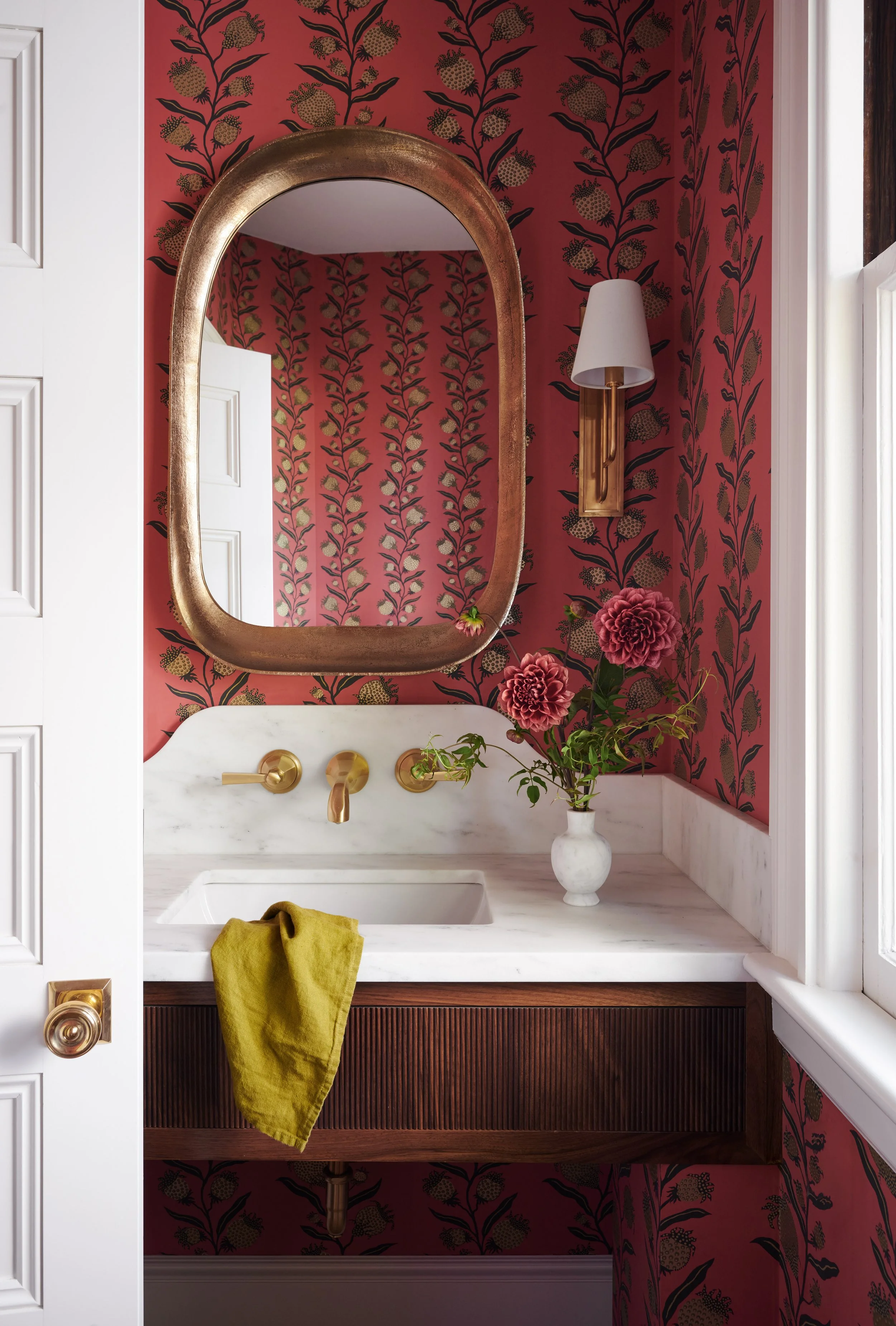 Powder room with coral floral wallpaper and fluted walnut vanity at Whitmore Road, Newburyport, designed by Ivory & Bone Interiors