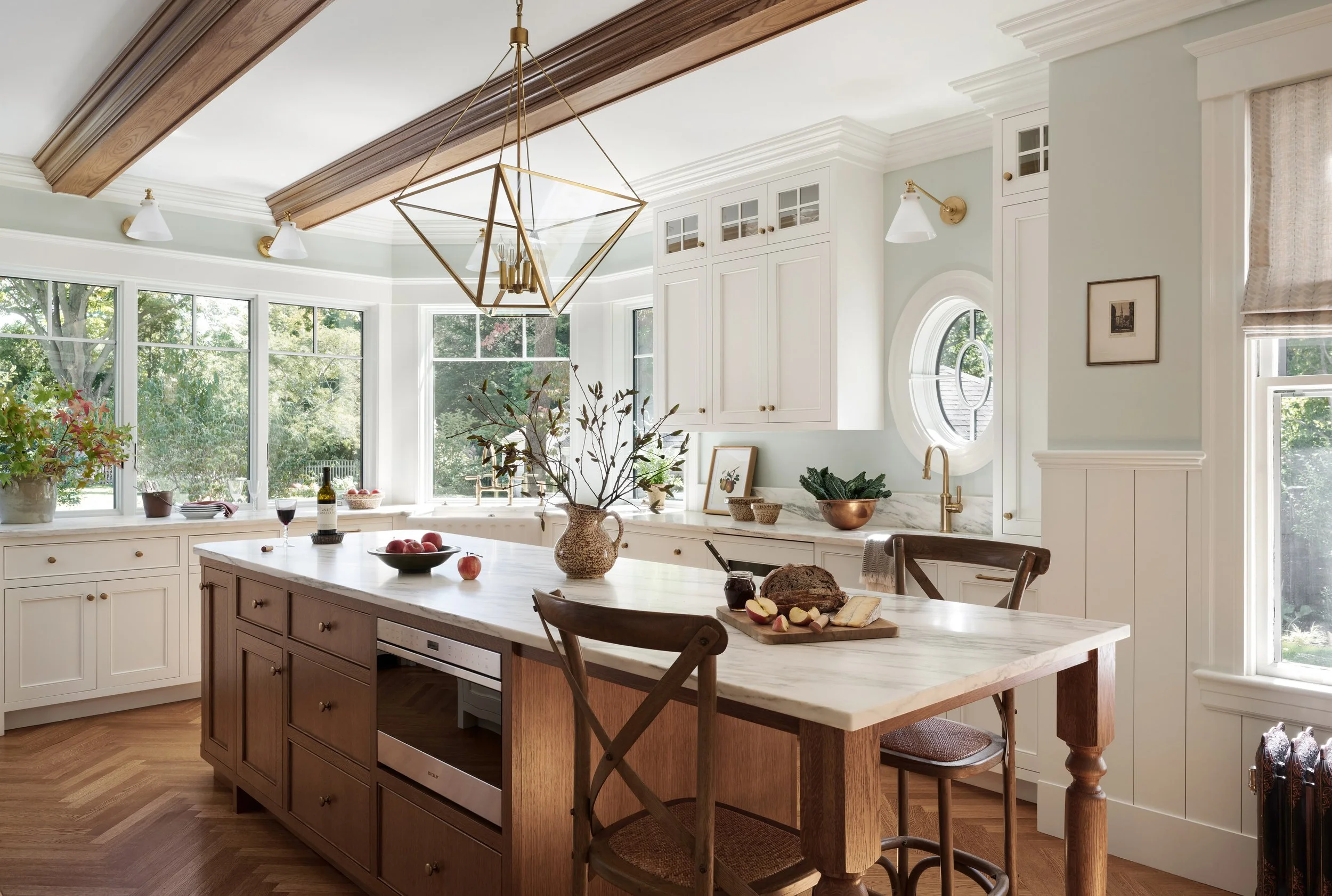 Cream kitchen with oak island, beamed ceiling and brass lantern at Whitmore Road, Newburyport, designed by Ivory & Bone Interiors