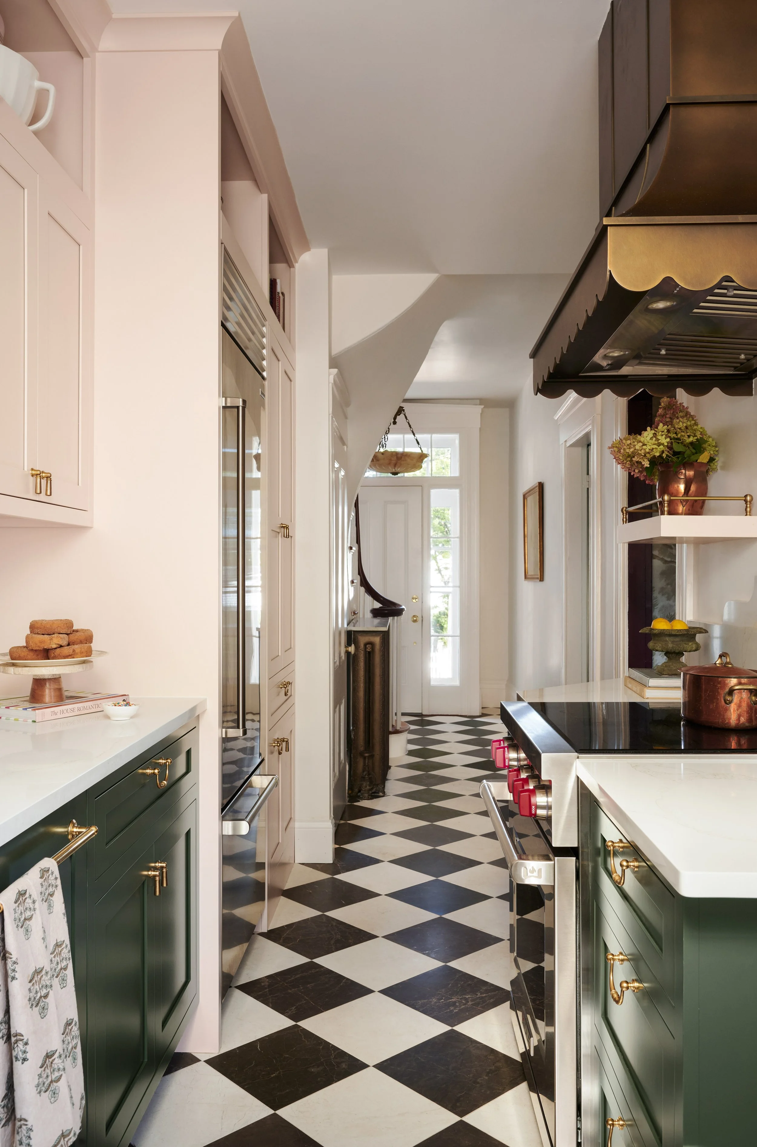 Kitchen with checkerboard floor opening to the front hall and staircase at Summer Street, Newburyport, designed by Ivory & Bone Interiors