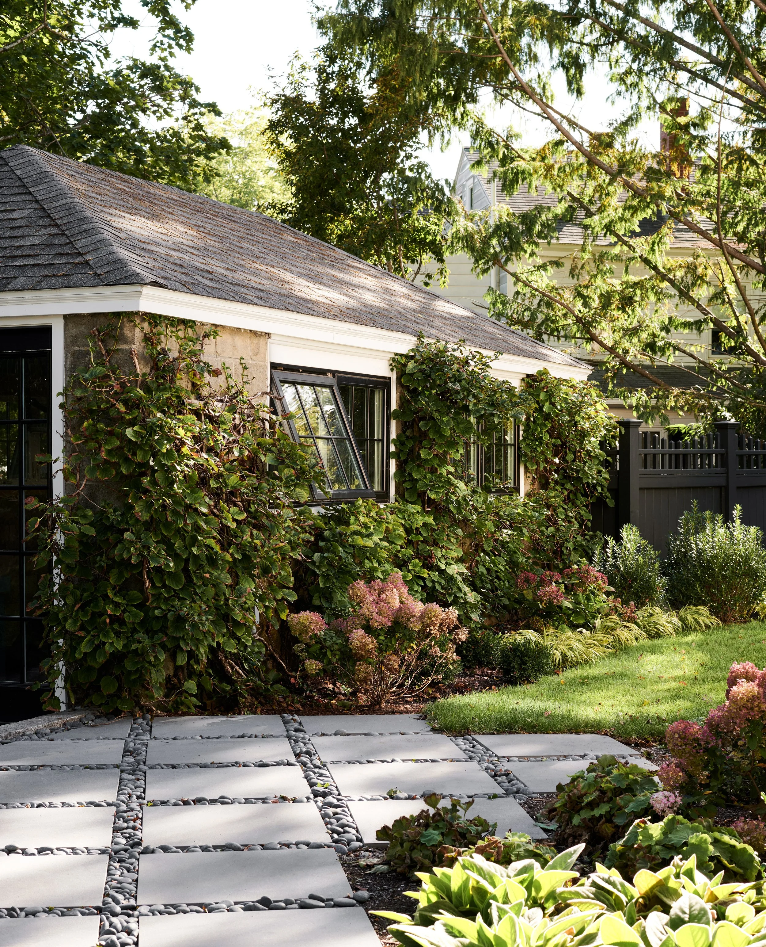 Vine-covered garage and stone paver path at Whitmore Road, Newburyport, designed by Ivory & Bone Interiors