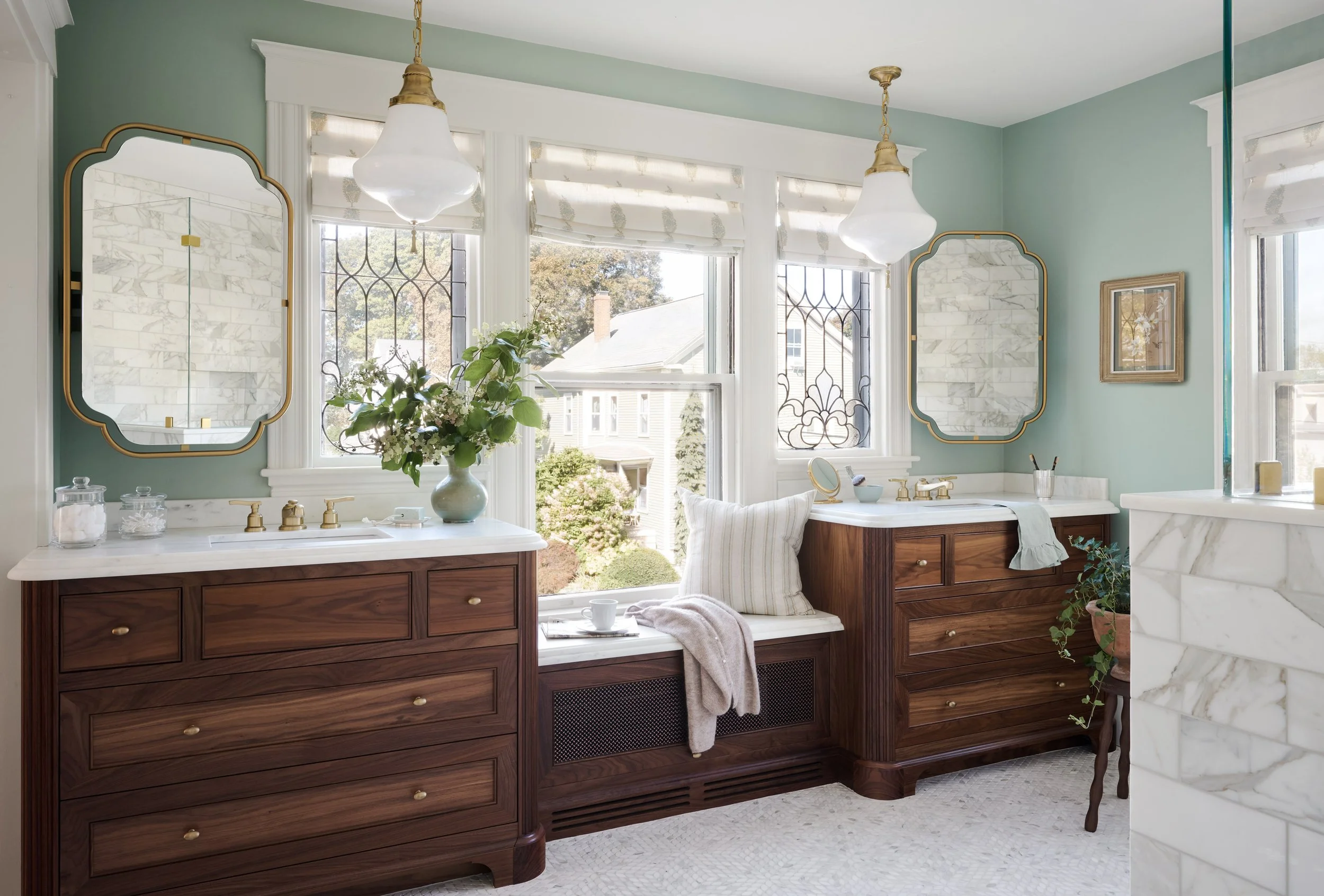 Primary bathroom with walnut double vanities and leaded-glass windows at Whitmore Road, Newburyport, designed by Ivory & Bone Interiors