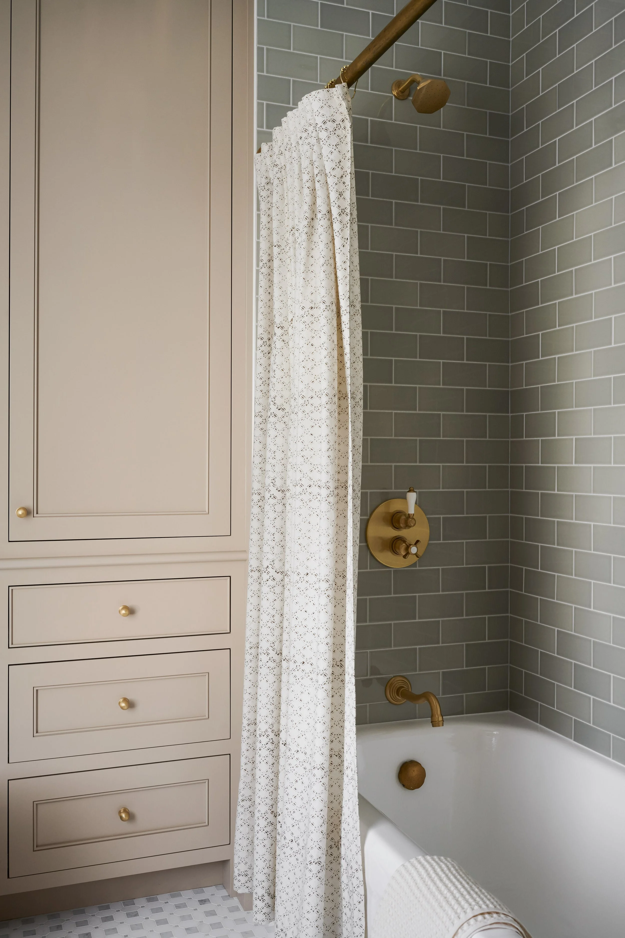 Guest bath with sage green subway tile shower and built-in linen cabinet at Whitmore Road, Newburyport, designed by Ivory & Bone Interiors