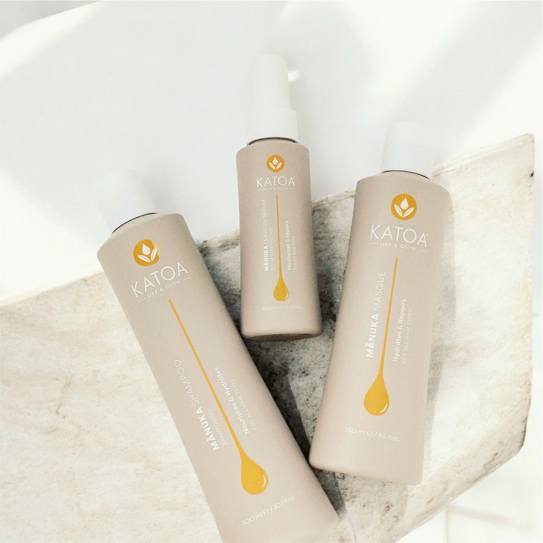 katoa hair care products on stone surface