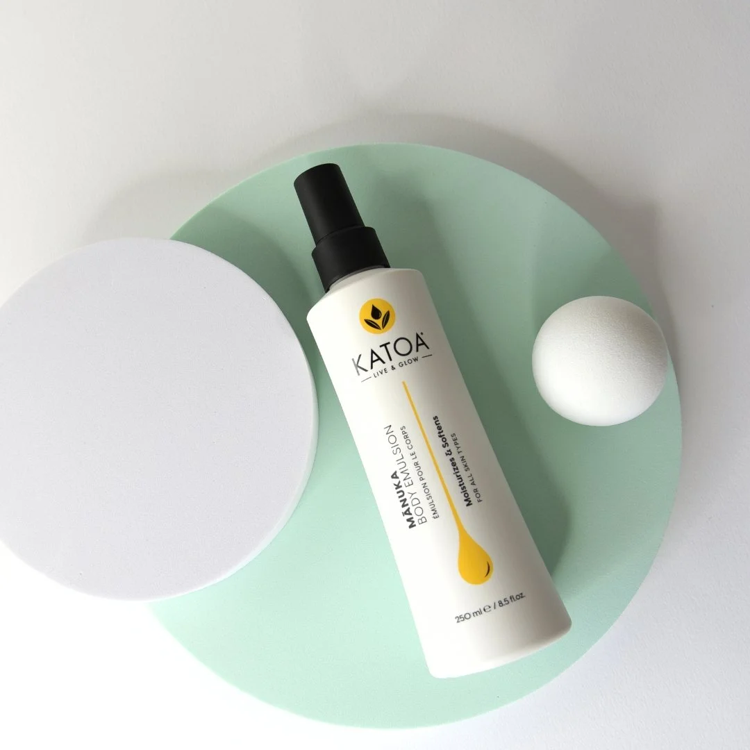 katoa body emulsion spray on green circle
