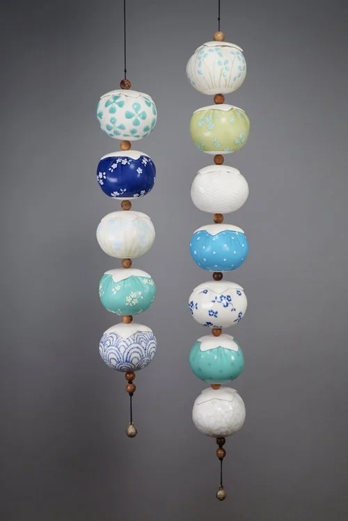 Dara Hartman | Pierce, 2023 | porcelain, paracord, wood beads, metal bell | 43 x 4 x 12 in. | Please contact gallery for pricing.