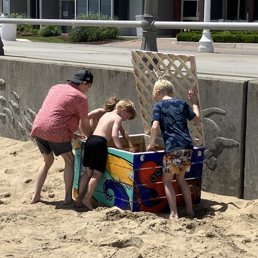 Kids looking for recycled beach toys in the KIBC Beach Toy Library