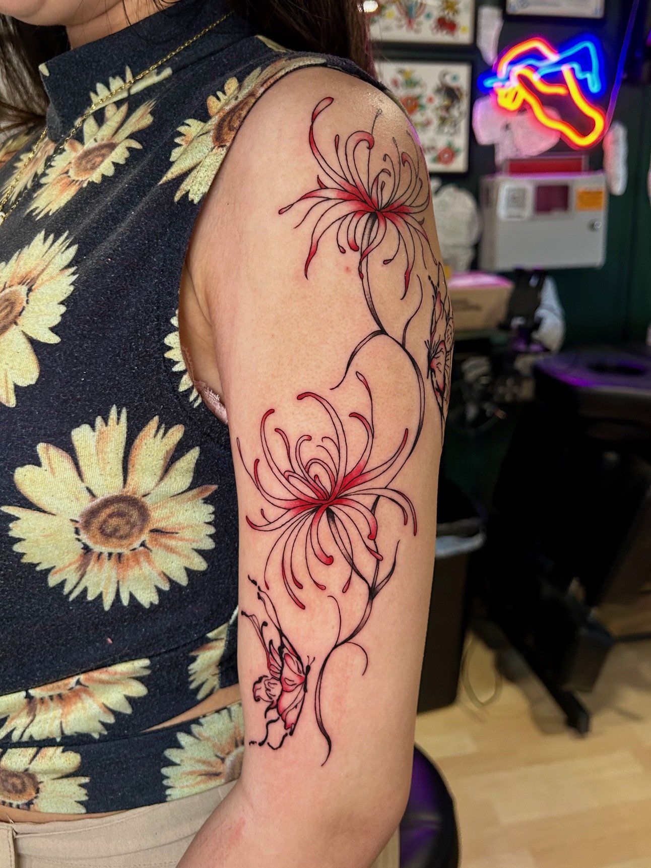 Fine line spider lilies tattoo by Nicole Cosner