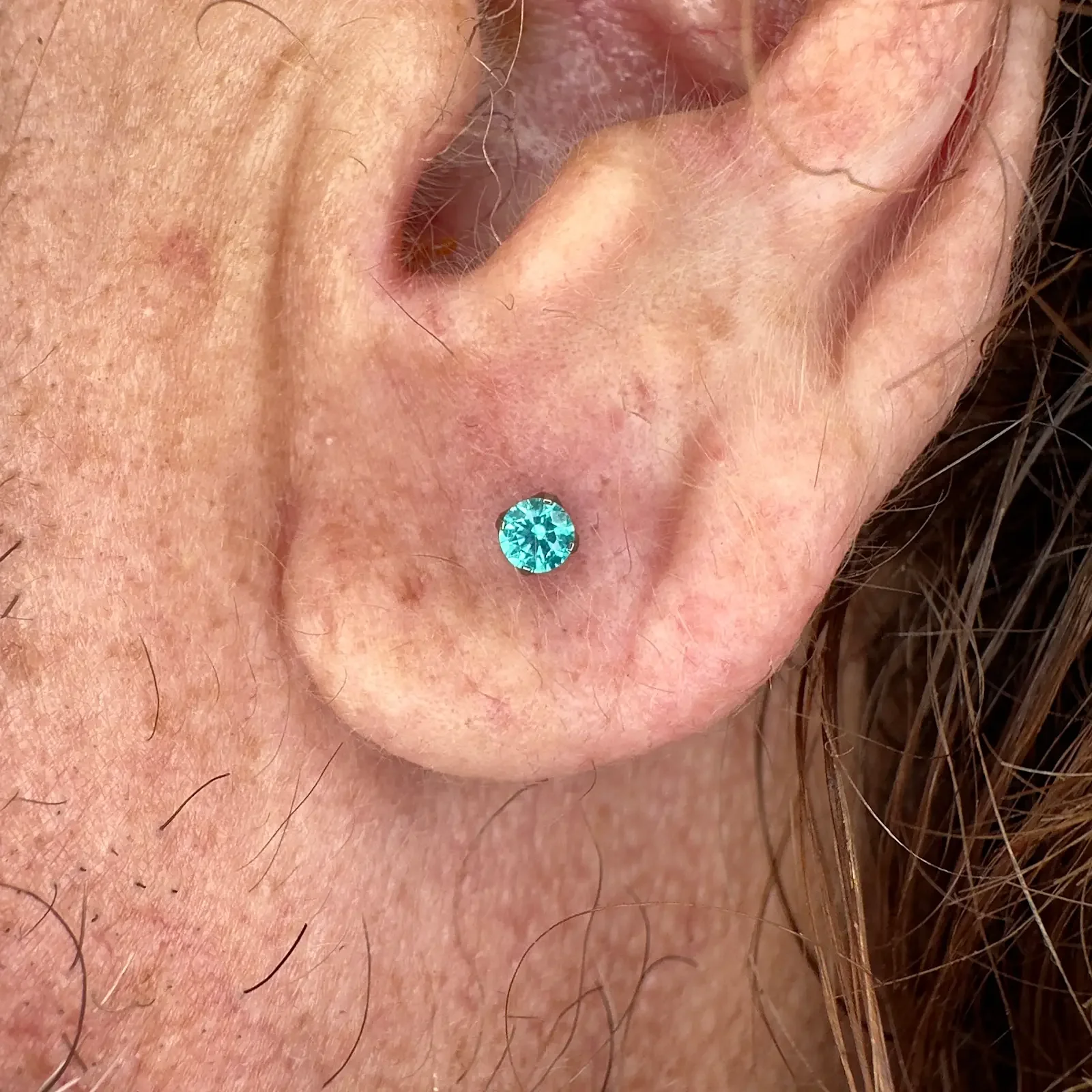 ear lobe piercing by Shannon Sanderson