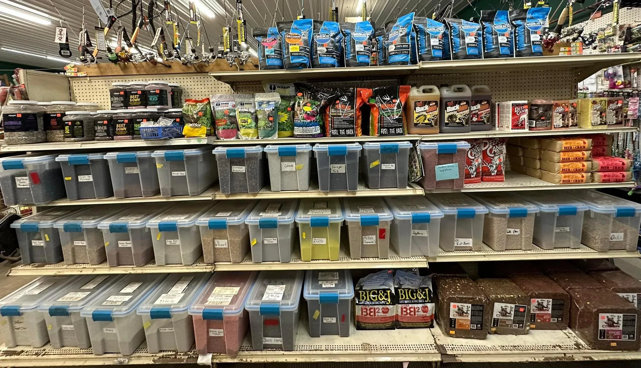 Fully stocked store shelf with various gardening and outdoor products, including seeds, fertilizers, and gardening tools.