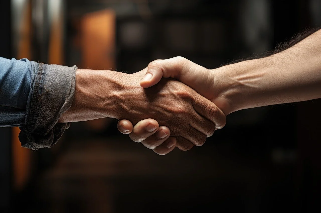 Two people shaking hands in a close-up shot.
