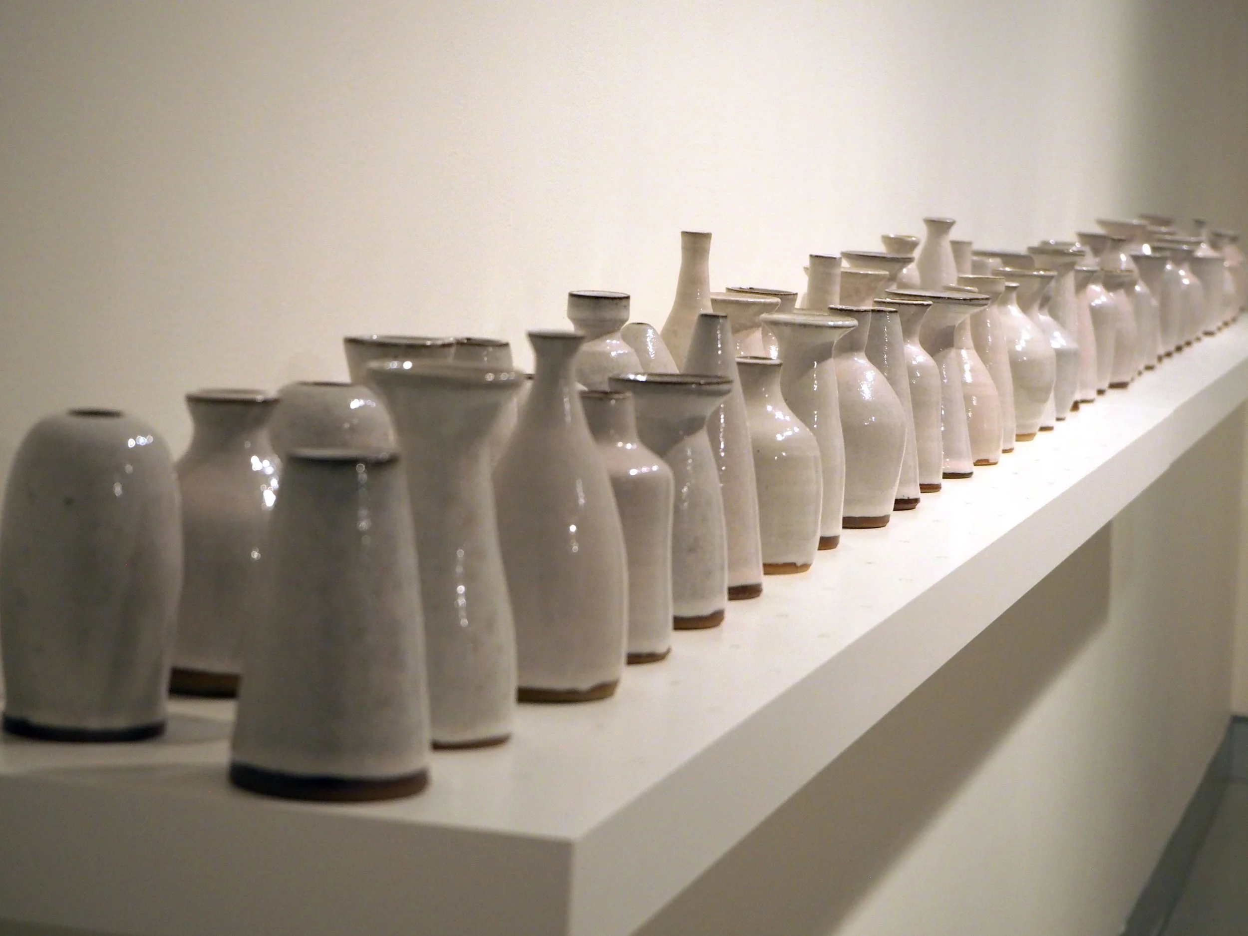 Oliver Carney Bud Vases Installation 2021 red stoneware, handmade tin glazes Photo: Silversalt