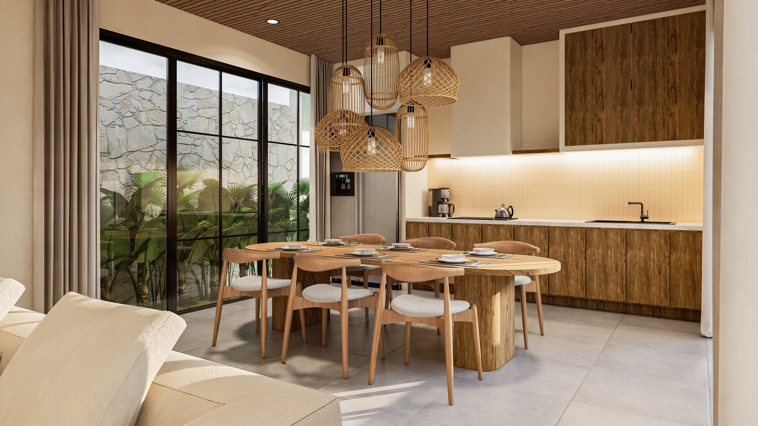 Modern kitchen and dining area featuring a wooden dining table with six chairs, overhead woven pendant lights, dark wood cabinets, a countertop with a sink, and a coffee maker. A large window with a view of a stone wall and greenery outside enhances