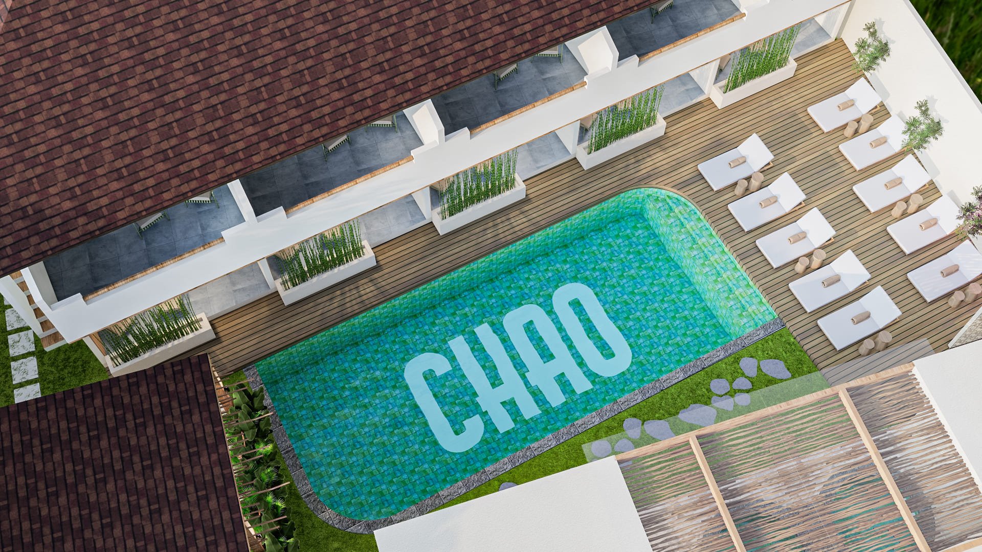 Top view of a rectangular swimming pool with the word 'CHAO' on its floor, surrounded by poolside loungers and a deck area, adjacent to a building with a tiled roof.