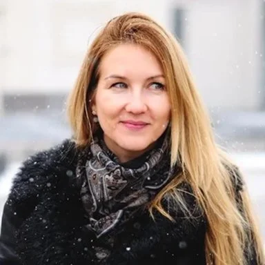 color photo of a smiling person under the snow