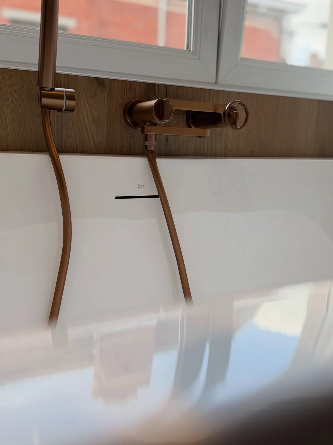 Gros plan robinetterie cuivrée baignoire îlot salle de bain La Bassée