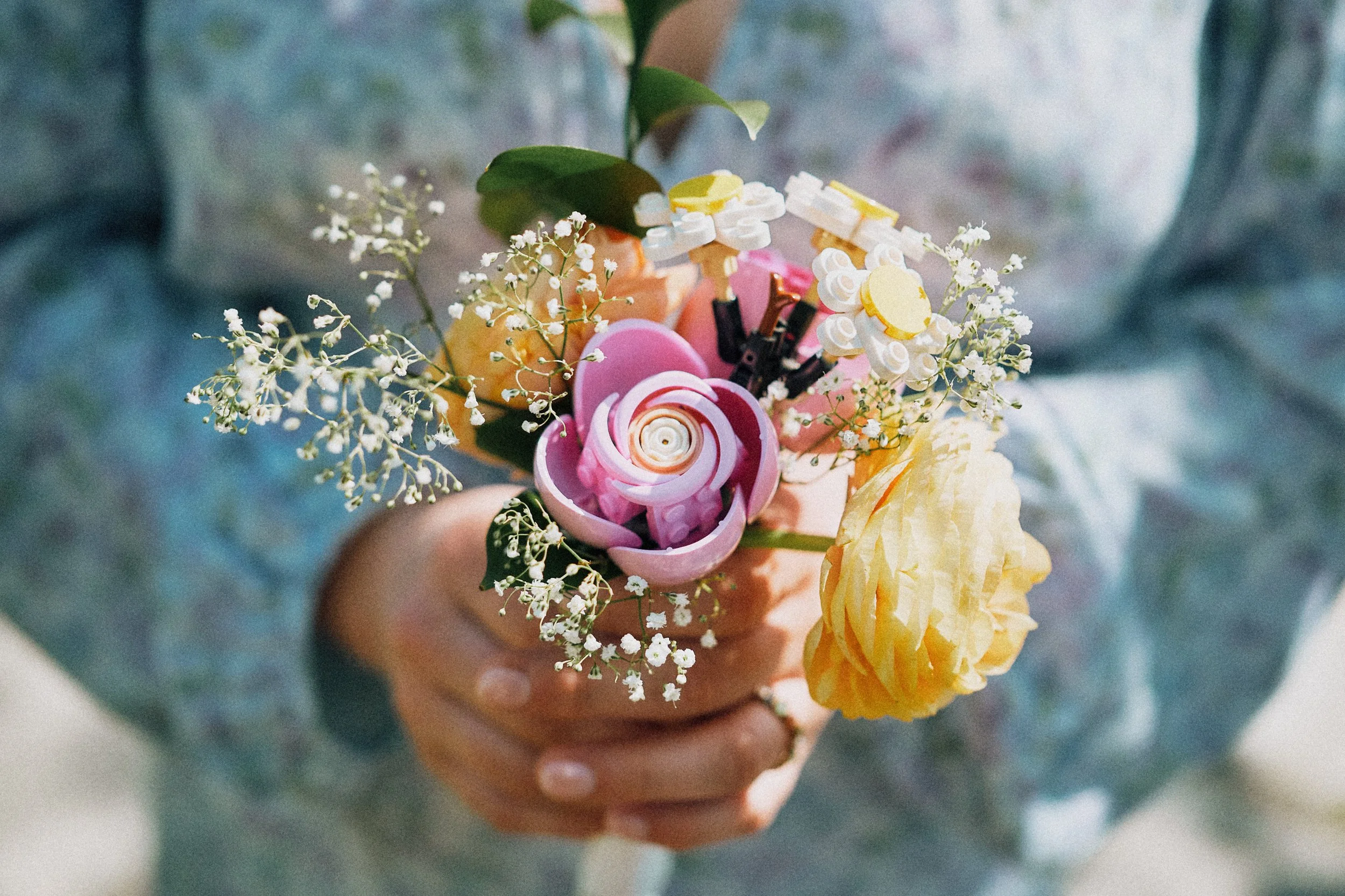 Bridal bouquet mixing real flowers and Lego pieces — a unique wedding bouquet idea photographed in Gothenburg by Anton Engblom