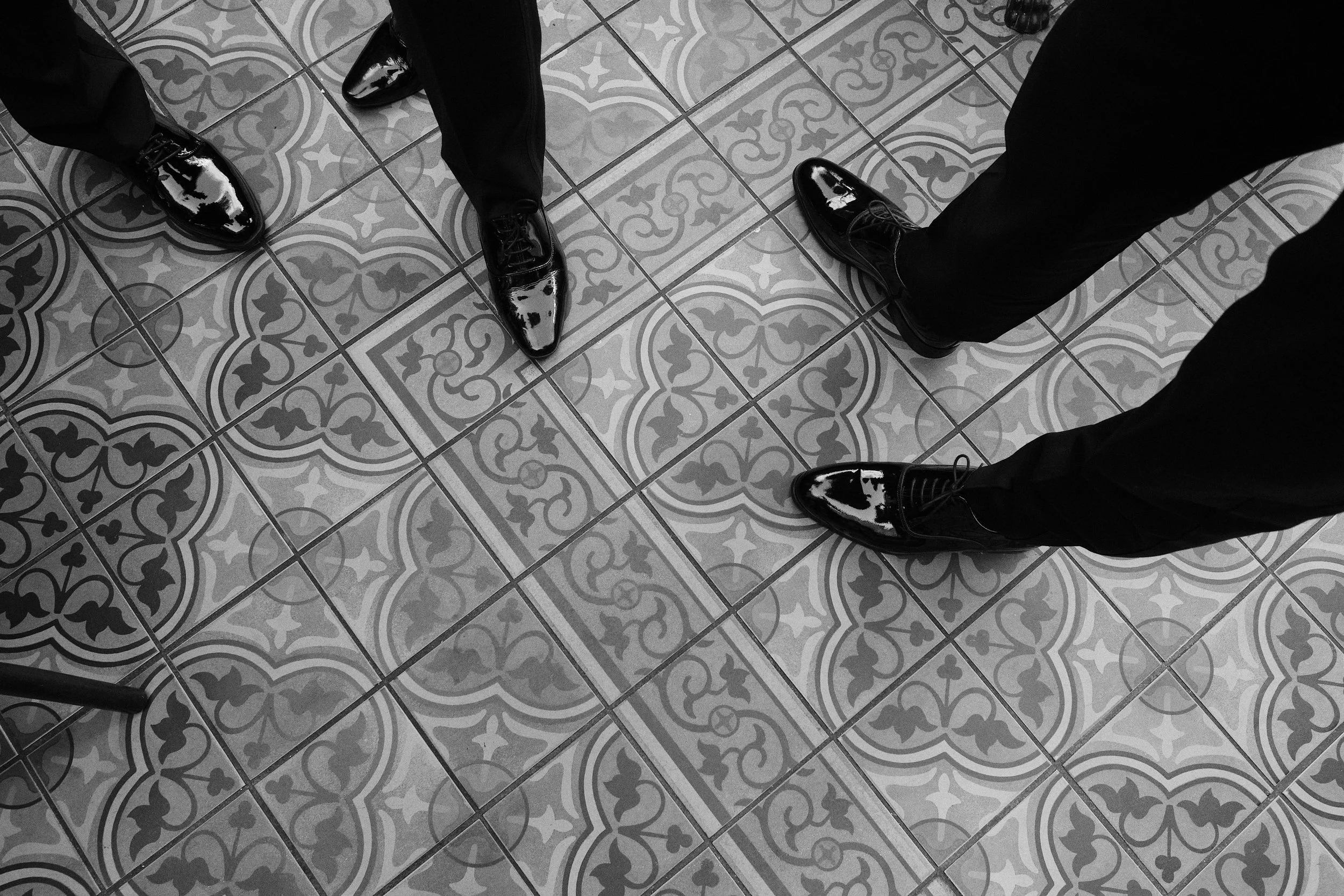 Groomsmen shoes on patterned floor at Dorsia Hotel in Gothenburg