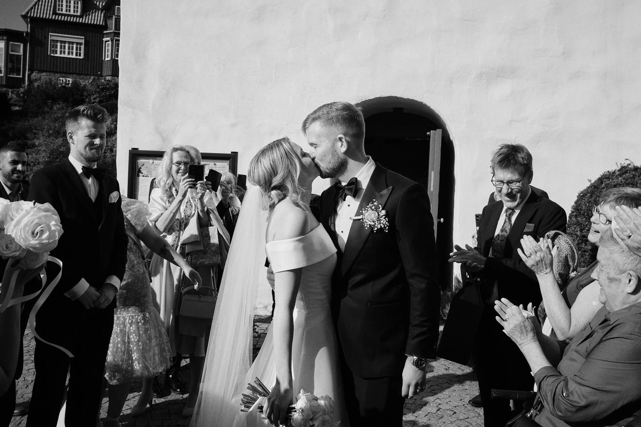 Bride and groom outside Örgryte Old Church in Gothenburg