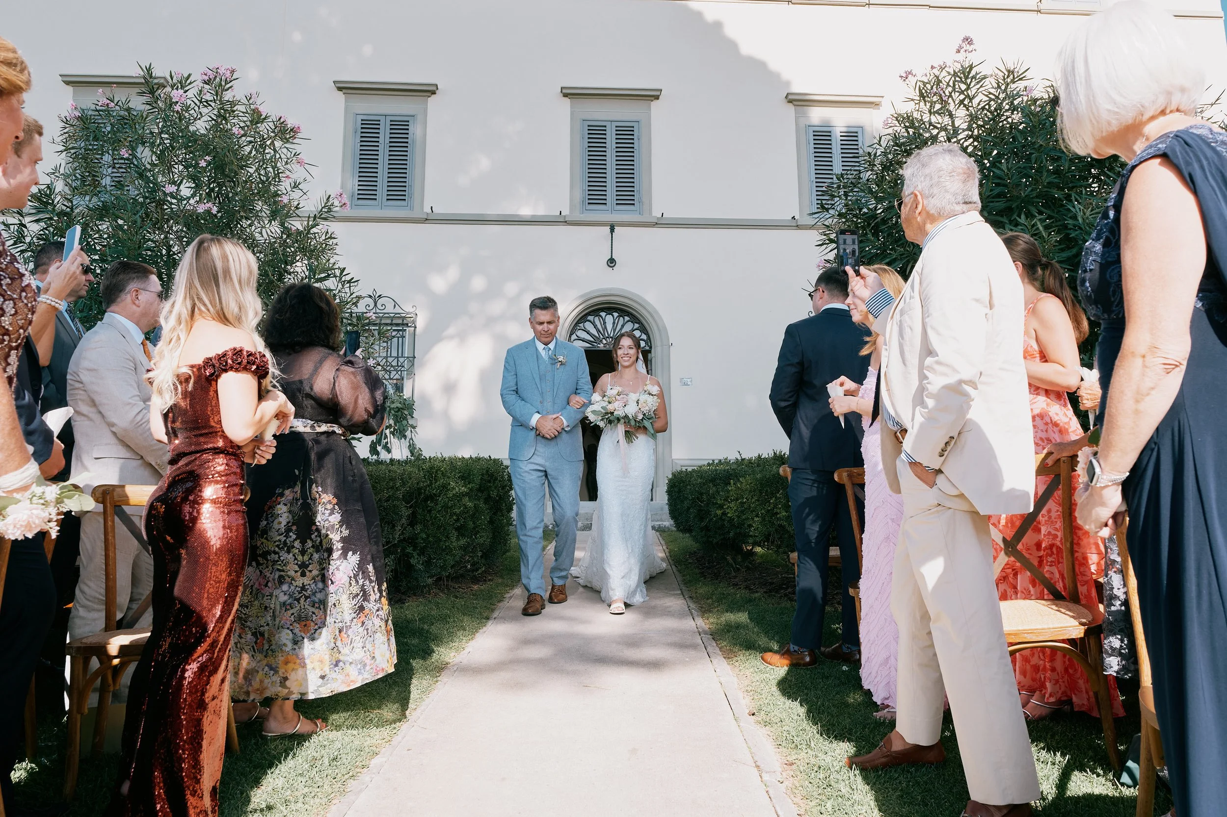 Bride walking down the aisle during Tuscany wedding ceremony