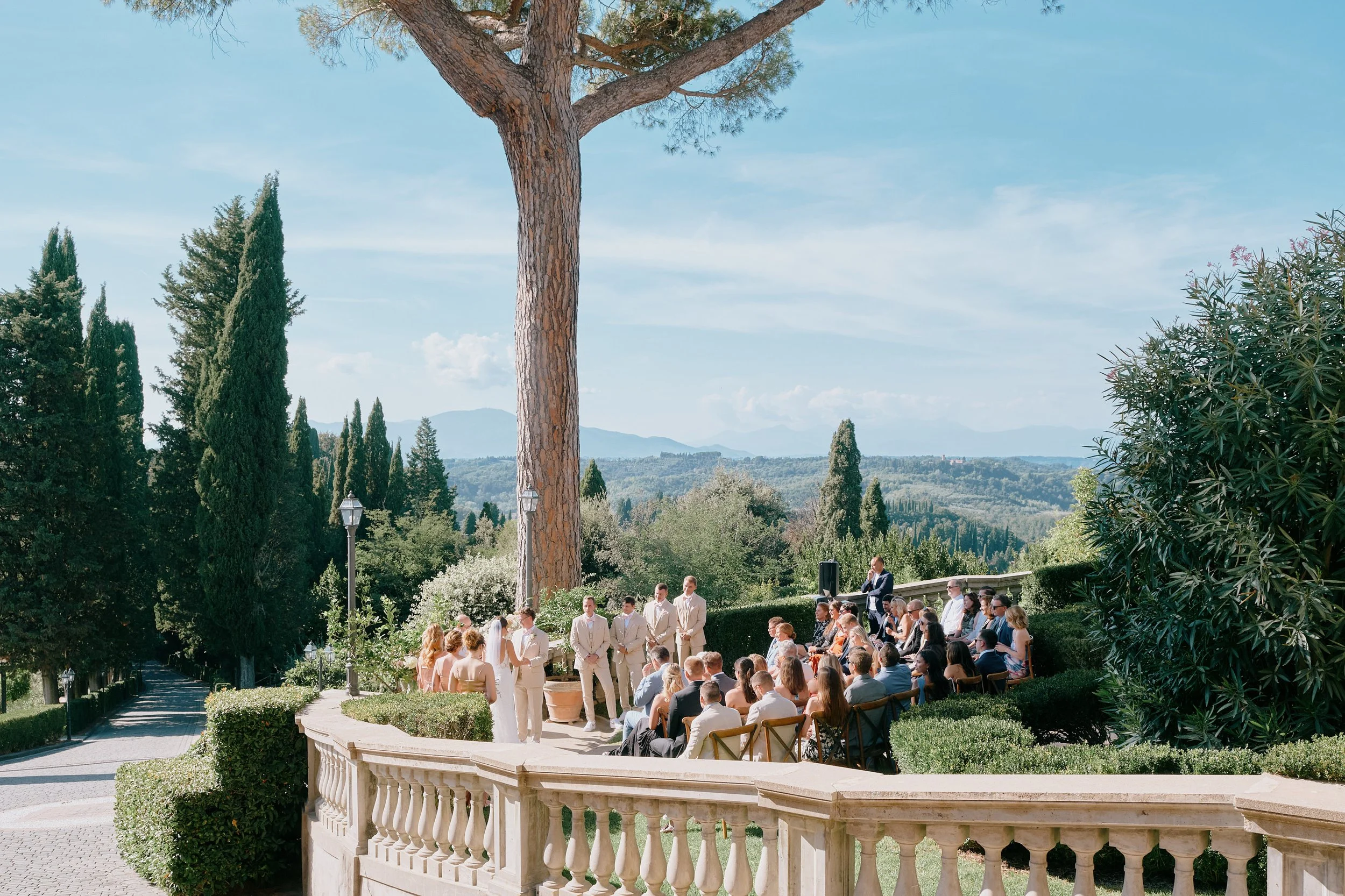 Wedding guests overlooking Tuscan countryside ceremony