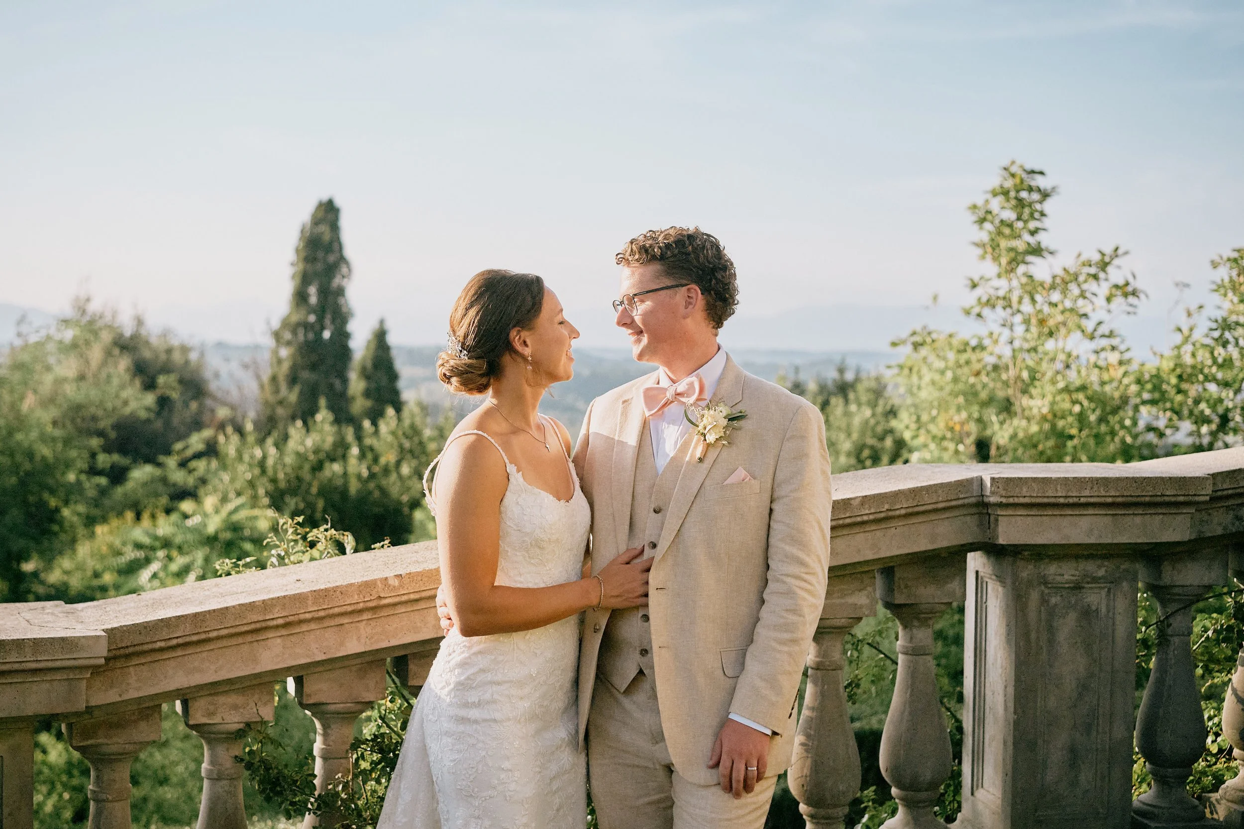 Bride and groom portrait overlooking Tuscan landscape