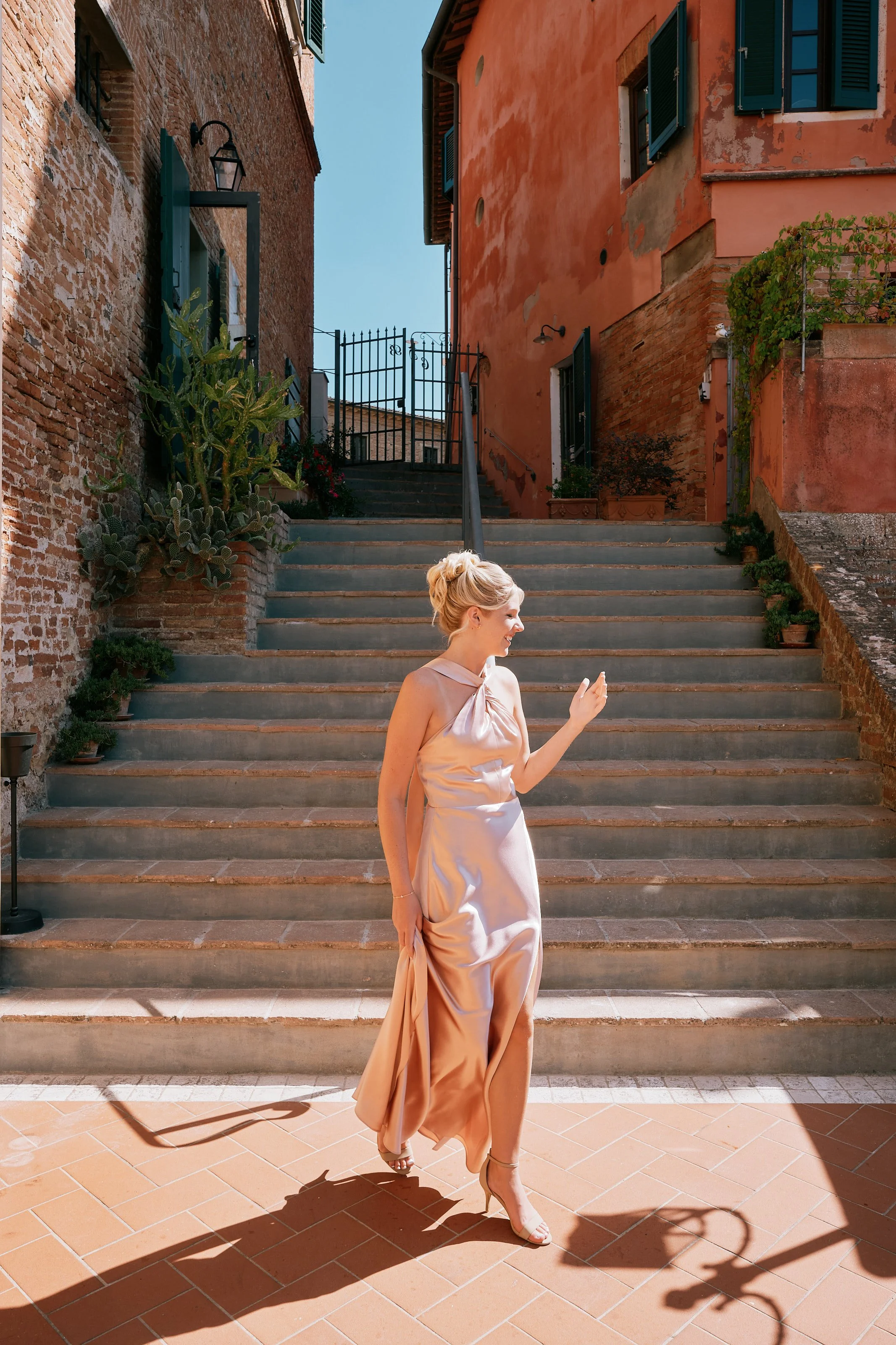 Guest walking through Tuscan village during wedding weekend