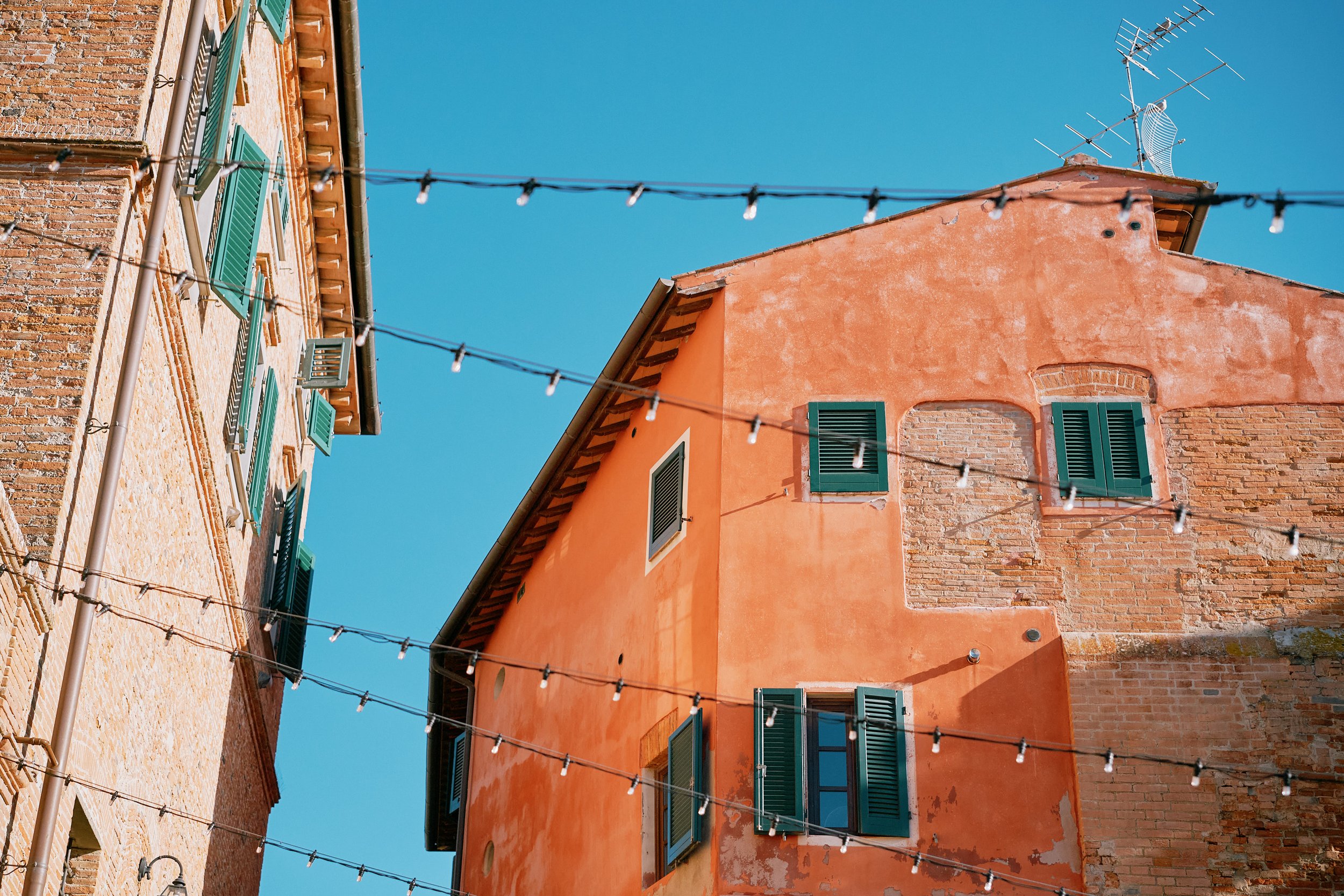 Tuscan villa facade with string lights in Italy